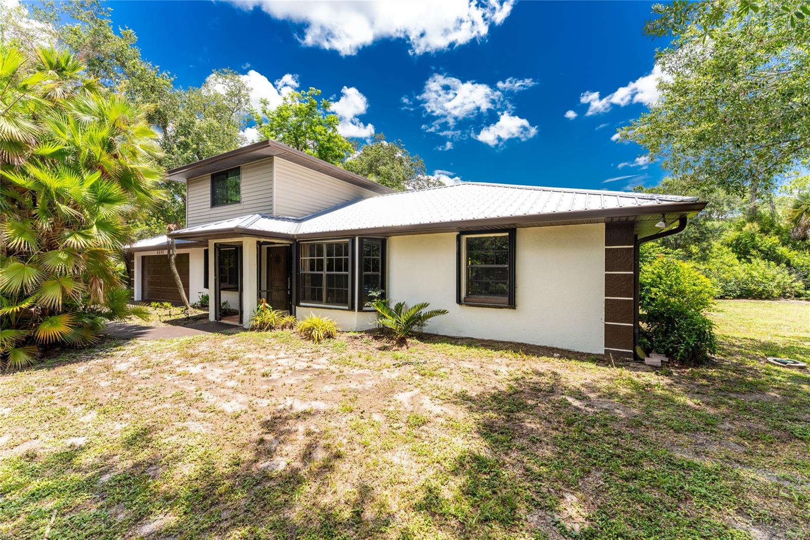 OFF the GRID feeling in the heart of a fantastic neighborhood! Welcome to your beautiful dream home situated on over one-half acre with tropical landscaping, including a waterfall in front!  This secluded and very private 2-story residence offers a warm and inviting interior with natural light dancing through the windows, highlighting the open floor plan.  There are four bedrooms and two full bathrooms, with the primary bedroom on the second floor for solitude. The fantastic beauty of this gorgeous home continues outside with a professionally landscaped exterior offering a retreat of serenity.  A newer metal roof ensures lasting durability for years to come, and built-in hurricane shutters provide ease and convenience.

The prime location is key - easy access to I-75 and US-41/Tamiami Trail; near to shopping, dining, and  numerous golf courses (Heron Creek Golf Course is just across Sumter Blvd), and a short drive to Atlanta Braves stadium, downtown Wellen Park, and SW Florida's world-renowned beaches.  Come see this beauty before it's too late!