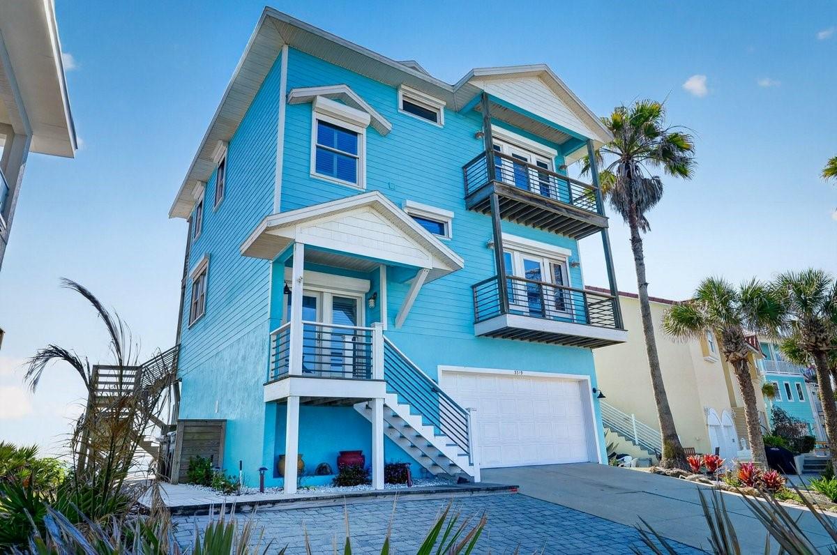 RARE DIRECT OCEANFRONT SHORT TERM RENTAL OPPORTUNITY! ''Blue Moon'' is a stunning 4-bedroom, 4-bath private oceanfront retreat in Flagler Beach that offers the perfect blend of relaxed beachfront living and exceptional investment potential, generating over $100,000 in annual rental revenue.
Designed to maximize natural light and commanding ocean views, the home features recently refinished hardwood floors and a beautiful open-concept second-floor kitchen, dining, and living area overlooking the Atlantic Ocean. The second floor also includes a guest bedroom and full bath, along with a private balcony offering western sunset views of the Intracoastal Waterway.
The first floor features a private guest suite with its own ensuite bath and direct walkout to the beach, creating an ideal retreat for guests.
On the top floor, a bonus living area connects the primary suite and an additional guest bedroom with full bath.
The primary suite is an ideal place to start your day with spectacular sunrises over the water, features a full-light door opening to an oceanfront balcony, a walk-in closet, and a spacious ensuite bathroom.
Outdoor living is just as exceptional with multiple entertaining spaces, private beach access via your own walkover with stairs directly to the sand, an outdoor shower, and a new shared CONCRETE SEAWALL. The home sits highly elevated on the dune, a prized oceanfront position that captures commanding views of miles of pristine Flagler Beach shoreline.
Recent upgrades include roll-down hurricane shutters, a new hurricane-impact slider, 2020 roof, brand new AC, and a new hot water heater.
A fully furnished package may be negotiated, making Blue Moon an exceptional turnkey oceanfront home or rental opportunity.