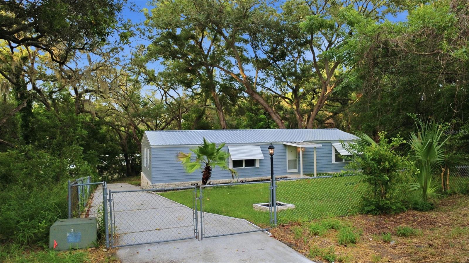 Virtually Staged. Welcome to your completely renovated and move-in ready home in Fruitland Park. Nestled on nearly half an acre beneath mature oak trees and situated on a quiet cul-de-sac, this beautiful home combines modern finishes with peaceful outdoor living. Inside, you’ll find a bright open floor plan with luxury flooring throughout, updated lighting, beautifully remodeled bathrooms, and a tastefully renovated kitchen complete with granite countertops. The versatile flex/bonus room provides endless possibilities and can easily function as a second living area, office, dining room, or playroom. Enjoy your morning coffee or evening sunsets from the oversized back deck overlooking the spacious backyard and natural surroundings. With everything updated and move-in ready, this home offers the perfect blend of comfort, style, and affordability. Conveniently located near shopping, dining, and The Villages while still offering privacy and space to spread out. Call today!!  All Realtor information is presumed correct but not guaranteed including dimensions, zoning, uses and description. Buyer and buyer's agent to verify all information.
