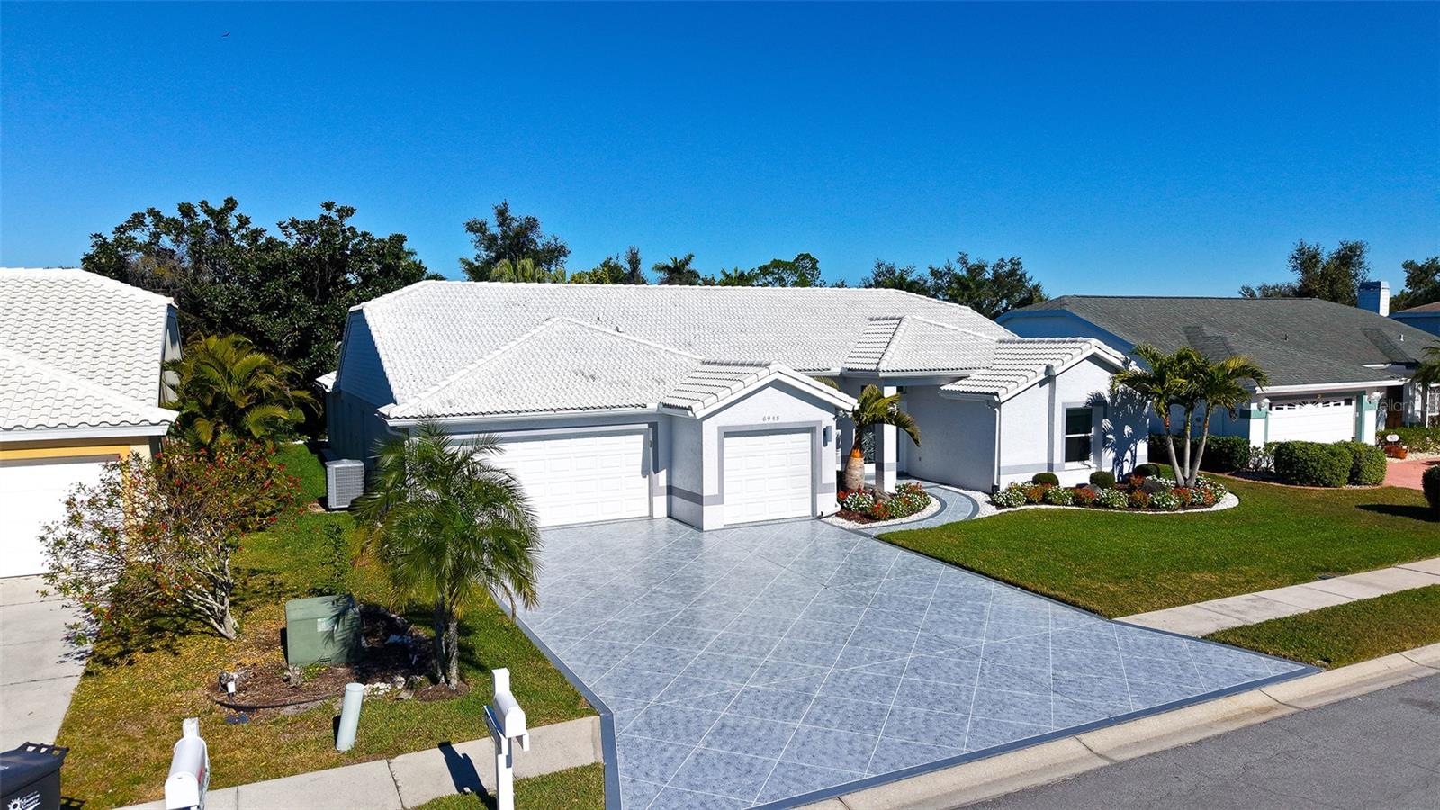 TURNKEY AND READY FOR YOU!!  Just bring Your Personal Belongings as this Stunningly Beautiful 3 Bedroom, 2 Bath Pool Home located in Mote Ranch will take Your Breath Away with the Custom Finishes Throughout.  Thoughtfully updated over the past few years, this nearly 2800 sq ft Home has been Lovingly Cared for and Reimagined with the Highest Standards.  Utilizing a Light and Modern Pallet, Sophistication was the Driving Force behind the New Design.  Upon Entry, You will be Greeted with Split Formals, the Oversized Living Room Immediately Draws your Attention to the Breathtaking Pool and Lanai that backs to a Lush Preserve Lot Dedicated to Privacy.  The New Cage Offers Spectacular Views of the Foliage with a Picture Window Screen Wall while the New Marble Deck adds Elegance as you Entertain or just Chill in the Quiet.  The Kitchen is Totally Custom and Created from the Ground Up. It will Speak to those of You that are Culinary Enthusiasts as it is Equipped with a Full Suite of GE Profile Stainless Steel Appliances including but not limited to Double Ovens, 36’’ Cooktop and Wine Refrigerator, Gorgeous Custom Cabinetry with Full Extension Drawers (all Soft Close of course) and “Double Thick" Caesarstone Quartz Countertops.  The Huge Center Island has an Abundance of Undercounter Storage, a Large Main Sink along with an Oversized Prep Sink.  The Custom-Built Cabinets include Hidden LED Lighting and Satin Nickel Hardware.  There's even a Separate Wine Bar for those who Enjoy the Bubbly.  Directly across from the Kitchen is an equally Amazing Family Room ready for “Movie Night” with surround sound ceiling speakers.  There are 2 Oversized Auxiliary Bedrooms and the 2 Bathrooms where you will see a Distinct Upgrade from the original home.  Each includes Custom Built Cabinets with white Caesarstone Quartz Countertops and Beautiful 12X24 Tile Floors and Grohe Fixtures.   There is a Fully Designed Office with one of the Custom Desks that Allows for a Sit or Stand Position with a Push of a Button and Built in Cabinetry is Perfectly Appointed for All Your Needs. The Floor Plan is Split to Maximize the Owner's Retreat for Privacy.  The Primary Bathroom has Accent Tiles that look like Falling Rain Behind the Large Free-standing Tub, the Walk in Shower if Beautifully Designed and Spacious. The Owner's Closet is Huge and Provides for Shoes, Clothing and Storage.  Other Features include Solid Core Interior Doors, The 3 Car Garage which has been Finished with Custom Cabinets, Hurricane rated Insulated Garage Doors and a Durable Epoxy Finish on the Floor.  Recent updates include New AC unit (2025), Hot Water Heater (2024), All New Landscaping (2025), Marble Pool Deck and Pool Cage with the Open Frame for Maximum Viewing (2025), Decorative Driveway Finish (2025).  Tile Roof Replaced in (2012). All windows and doors are PGT Hurricane rated (2015). This Home Leaves Nothing to the Imagination!!  Literally there is Nothing Left TO DO!!  All of this and UTC, the West Coast Beaches and Literally 100s of Restaurants all within Minutes...