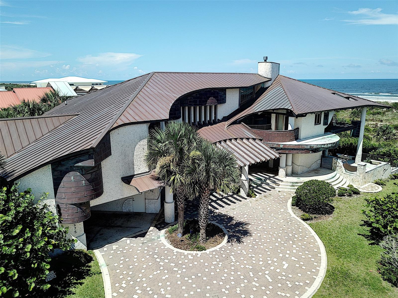 Exceptional ocean front family home, 2 gas fireplaces, central heat and air with four zoned units, each bedroom has an individual bathroom, office with built in desk and upper cabinets, built in shelves thruout, abundance of closets, lst floor 2,577 sq ft, 2nd floor 3,263 sq ft, SS appliances in kitchen, Thermodore gas cook top, Thermodore wall oven and microwave, granite and limestone countertops, wet bar with SS sink, custom maple and cherry cabinets, Anderson windows thruout with impact glass, all butt glass to stand 120 mph wind, beams are of pre-engineered laminated and Tide Water Cypress, copper roofing, pool and hot tub, with glass tile interior with disappearing ledge and stepping stones, gas pool heater, pool deck is Macedonian Stone. Well and timer for irrigation system for several zones, exterior balconies, oversize garage and carport, many more extras, come see for yourself, you wont be disappointed in this beautiful home. ;Water: City