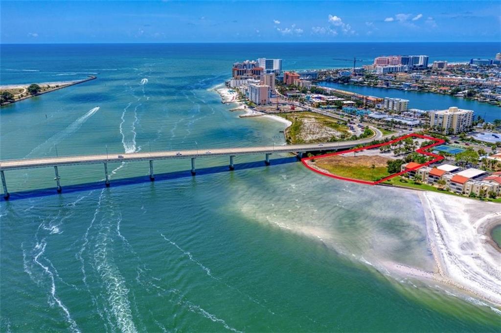 ONE OF THE LAST VACANT AND BUILDABLE LOTS ON WORLD-FAMOUS CLEARWATER BEACH.  This is an opportunity to develop 3.20 Acres MOL into the next destination resort, condominium or world-renowned restaurant.  Recently approved for luxury condominium units. 
Situated at the base of the Sand Key Bridge and surrounded by shopping and dining, this prime waterfront location offers an expansive 300 feet of seawall.  There’s virtually 180 degree sweeping views of the intracoastal waterway, Clearwater Pass and the Gulf of Mexico from this southern facing location.  Conveniently located near the Sand Key Bridge and the Memorial Causeway to easily access to the main land—and the last trolley stop before Sand Key.  Only 30 minutes to Tampa International Airport!  The location has been part of the City of Clearwater’s Beach by Design masterplan and is the last parcel in the City’s Beach Community Redevelopment District on the southern end of Clearwater Beach.   A top attraction for locals and visitors, Clearwater Beach is consistently voted a top beach in Florida and the U.S.  The Clearwater Marine Aquarium is just minutes away and popular Clearwater Beach are awaiting the next great addition to Florida’s Gulf Coast.