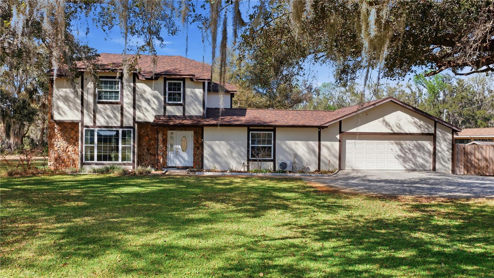 Calmness at the end of the cul-de-sac. Check out this 4bd. 3 bath Tudor style home. If your looking for a well cared for family size home or a home with an in-law suite then this could be the one. Situated on a .57 acre shady lot. A serene canal meanders around the back yard and around the neighborhood. Providing a place for Kayaks and canoes to travel uninterrupted on a lazy days canal landlocked from the open lakes. Inside you will find a picturesque bay window in the Living room with a wood burning fireplace. A large eat in kitchen with granite countertops for the Chef in the house. 3 bedrooms and 2 full baths upstairs includes a primary suite. Downstairs offers a 20 x 21 bedroom suite with handicap features in it's private bathroom. New Roof 2025. Enjoy your morning coffee on a 13 x 33 screened enclosed back porch and a dip in the Hot tub on it's screened porch area. To complete this well equipped home an oversized 2 car garage has room for the cars and much more. The present owners have lived in and continued to update and create a welcoming home here for 43 years.