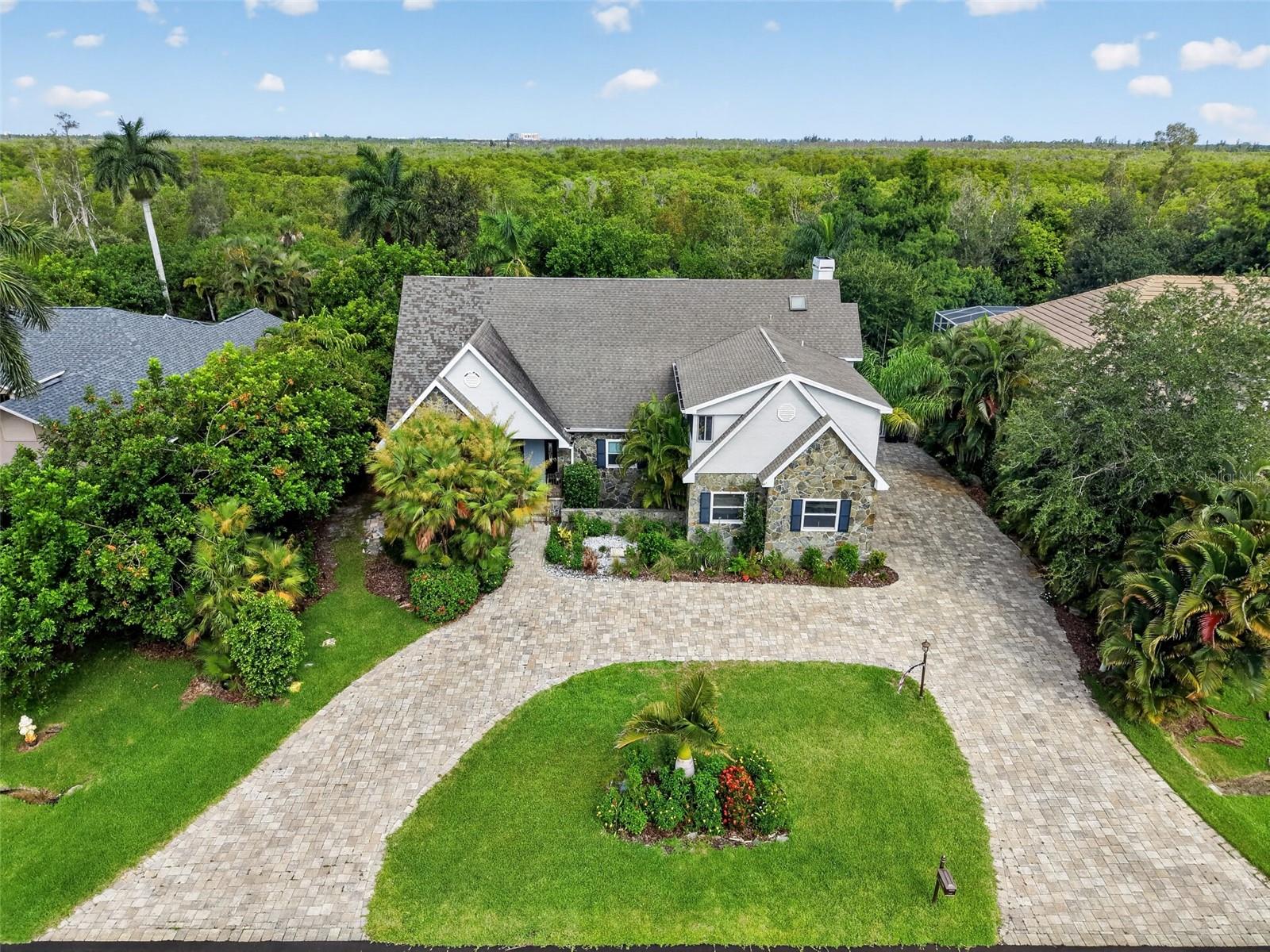 5 BEDROOM 4 BATH POOL HOME WITH SPA IN THE FOREST COUNTRY CLUB — GATED GOLF COMMUNITY IN FORT MYERS! NEW ROOF 2022 AND WATER HEATER 2021! This stunning Cape Cod estate offers over 3,830 sq ft of living space on a beautifully landscaped 0.33-acre lot, making it one of the largest single-family homes available in Southwest Florida at this price point. Features include an in-ground private pool and spa, wood and bamboo flooring throughout, crown molding, a wood-burning fireplace in the living room, and an open-concept layout ideal for entertaining. The gourmet kitchen offers generous counter space and ample cabinetry flowing into the main living and dining areas. The expansive primary suite includes a spa-like en-suite bath and walk-in closet. Four additional bedrooms provide flexibility for guests, home office, gym, or multi-generational living. Attached 2-car garage, dedicated laundry room, covered porch and patio. HOA $3,200/year. Located minutes from Fort Myers Beach, Sanibel Island, Bell Tower Shops, Coconut Point Mall, Gulf Coast Medical Center, US-41, and I-75. All financing welcome including FHA, VA, and conventional. Priced to sell — schedule your private showing today!