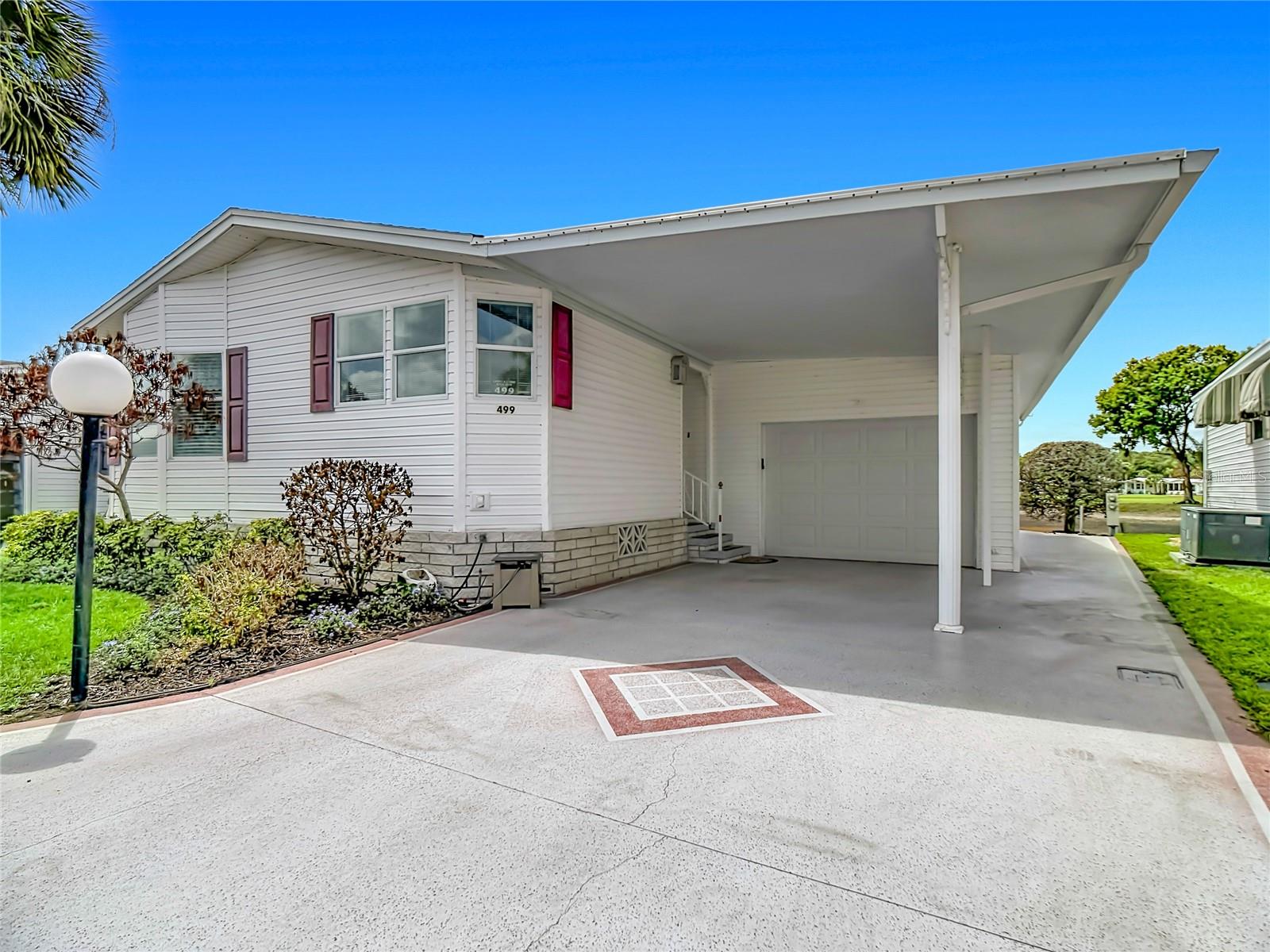 ***Price updated.  Incorrectly entered with wrong price

Beautifully furnished 2BR/2BA home overlooking the golf course and a peaceful pond in the sought-after Lily Lake Golf & RV Resort. The bright front kitchen features windows across the front of the home, flowing into a welcoming dining area and cozy den. The back of the home opens to expansive golf-course views through multiple windows, plus a patio perfect for Florida sunsets.

The layout includes a comfortable guest bedroom with nearby bath, an interior laundry area, and a spacious main bedroom with en suite. A rare one-car garage plus golf cart parking adds tremendous value.

Enjoy resort-style living in this golf cart community with a clubhouse, pickleball, tennis, shuffleboard, two dog parks, low POA fees, underground utilities, seasonal dances, golf cart parades, and year-round water aerobics. Golf cart rentals are available at the Lily Lake Pro Shop, where you’ll also find many scrambles and ongoing golf events. Bring your clubs, your cart, and your flip-flops — this is the Florida lifestyle at its best.