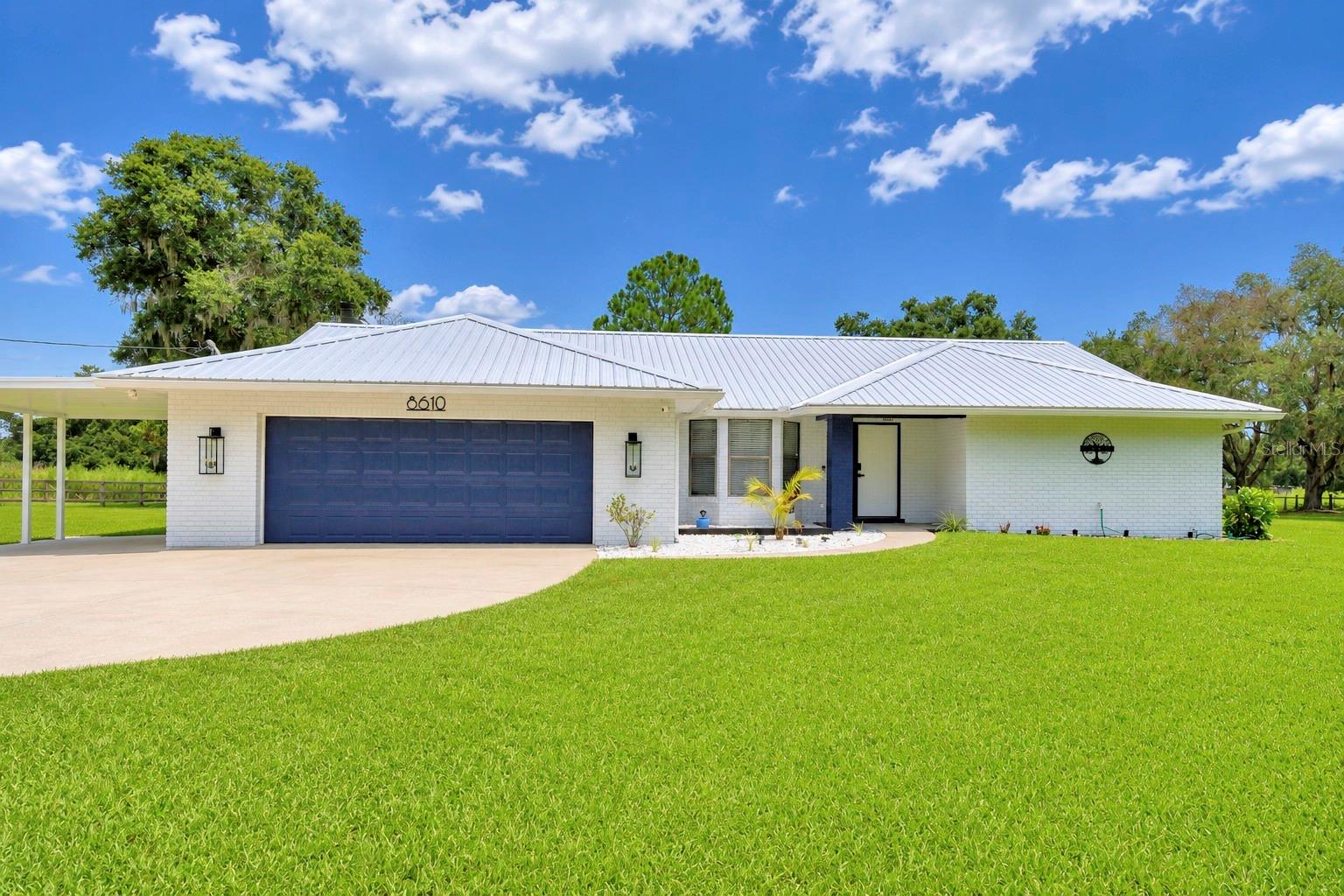 Welcome home to this beautifully maintained 4-bedroom, 2-bath pool home situated on 1.01 acres, offering the perfect blend of privacy, functionality, and outdoor living. The property features a 2-car garage, single-car carport, 28' x 24' workshop, chicken coop, and a separate bird aviary, making it ideal for hobbyists, animal lovers, or anyone looking for extra space.
Step inside to discover beautiful tile flooring throughout and a warm, inviting living room highlighted by a stunning brick wood-burning fireplace. The well-appointed kitchen features wood cabinetry, quartz countertops, sleek white appliances, a convenient breakfast bar, and an open layout overlooking the living room—perfect for everyday living and entertaining. Just off the kitchen is a formal dining room enhanced by a beautiful bay window, creating an inviting space for family dinners and holiday gatherings. An inside laundry room, conveniently located just off the garage entry, adds everyday functionality.
The spacious primary suite serves as a private retreat with sliding glass doors leading directly to the screened pool and expansive lanai. The ensuite bath offers a relaxing soaking tub, walk-in shower, dual-sink vanity, and plenty of room to unwind.
Three additional bedrooms provide comfortable accommodations, with two bedrooms featuring sliding glass doors that open directly to the pool area, creating a seamless indoor-outdoor lifestyle. The guest bath is beautifully updated with quartz countertops, a dual-sink vanity, a tub/shower combination, and convenient direct access to the pool.
Step outside and enjoy your own private backyard oasis. The screen-enclosed inground pool and oversized covered lanai provide the perfect setting for weekend barbecues, family gatherings, or simply relaxing while overlooking your peaceful acreage. With 1.01 acres, you'll have plenty of room for gardening, outdoor activities, pets, or simply enjoying the privacy and open space.
Need extra room for projects or storage? The impressive 28' x 24' workshop offers endless possibilities for woodworking, mechanics, hobbies, crafts, or storing equipment. The property also includes a chicken coop and a separate bird aviary, making it a wonderful fit for those who appreciate a touch of country living.
Enjoy the best of both worlds with peaceful country-style living and convenient access to I-4, placing Lakeland, Orlando, Tampa, shopping, dining, and entertainment all within easy reach.  Don't let this one get away—schedule your private showing today and discover all this beautiful property has to offer!