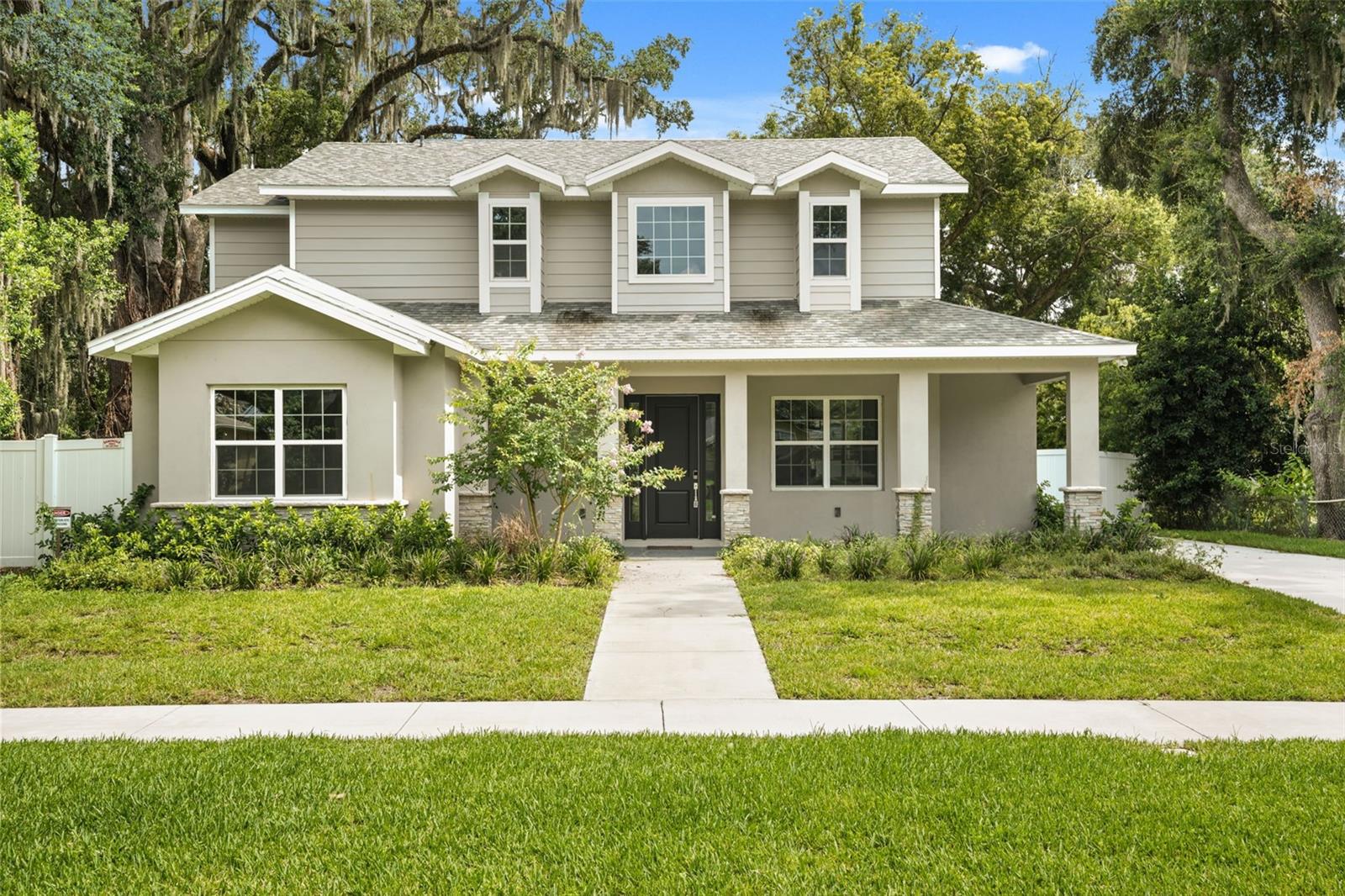 Construction of a custom two-story single-family residence designed to provide approximately four bedrooms with a dedicated study/den that may function as an optional fifth bedroom. The residence includes an attached two-car garage, covered front entry porch, and a functional open-concept floor plan designed for modern family living.
The exterior architecture features a Craftsman-inspired design incorporating horizontal fiber cement lap siding, smooth stucco wall finishes, decorative brick veneer accents, architectural asphalt shingles, and decorative trim details. The front elevation includes multiple gabled rooflines, dormer elements, and energy-efficient insulated windows to provide enhanced curb appeal and natural daylight.
The interior layout is designed to maximize functionality with spacious living and dining areas, a centrally located kitchen, private owner’s suite, secondary bedrooms, flexible study/den space, and ample storage throughout. The study is sized and located to allow conversion to a fifth bedroom if required by the owner.
Construction consists of a reinforced concrete foundation, wood frame structural system, engineered roof trusses, and materials installed in accordance with the approved construction documents, the Florida Building Code, and all applicable local building regulations. Mechanical, electrical, plumbing, and life-safety systems are designed to comply with current code requirements and energy efficiency standards.
The completed residence is intended to provide a durable, energy-efficient, and high-quality custom home with approximately four bedrooms plus a flexible study/optional fifth bedroom, combining architectural character with long-term functionality and value.