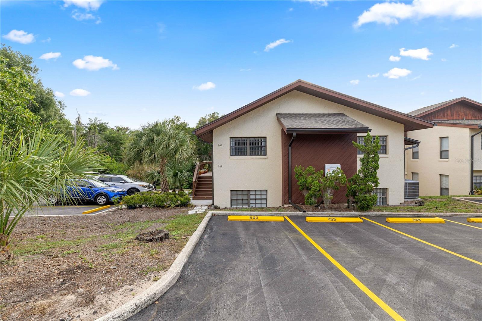 Welcome to 964 5th Street, Clermont, FL 34711, where comfort, convenience, and the vibrant charm of historic Clermont come together. Nestled in the peaceful Lake Dot Villas community, this beautifully maintained condo offers an exceptional opportunity for first-time homebuyers, snowbirds, investors, young professionals, or anyone looking to downsize without sacrificing location or lifestyle. Built during an era known for quality craftsmanship, this solidly constructed home has been lovingly cared for and is truly move-in ready. Inside, you'll find a warm and inviting layout designed for easy, low-maintenance living. Step outside to your private screened-in porch, where you'll enjoy tranquil views overlooking Lake Dot and the surrounding green space. Whether you're sipping your morning coffee, relaxing after a long day, or entertaining family and friends on the adjacent brick-paver patio, this outdoor retreat offers the perfect setting to enjoy Florida living. A spacious exterior storage closet provides plenty of room for bikes, golf clubs, seasonal décor, and more. The community has undergone significant recent improvements, providing peace of mind for years to come, including new roofs and fresh exterior paint completed in 2024, as well as new stairways and freshly resurfaced parking areas completed in 2025. Each owner also enjoys the convenience of two assigned parking spaces. One of the greatest features of this home is its unbeatable location. Situated just a few blocks from Historic Downtown Clermont, you'll love being able to walk or bike to an incredible selection of locally owned restaurants, charming cafés, boutique shops, and the area's popular craft brewery. Spend your weekends browsing the Clermont Farmers Market and artisan markets, enjoying community festivals, or taking in live music and entertainment throughout downtown. Outdoor enthusiasts will appreciate being just minutes from Lake Minneola, Waterfront Park, the South Lake Trail, and the Clermont Boat Ramp, offering endless opportunities for walking, running, cycling, kayaking, boating, fishing, and paddleboarding. Clermont is nationally recognized as the "Choice of Champions," attracting athletes from around the world thanks to its rolling hills, scenic trails, and the nearby National Training Center. Throughout the year, enjoy exciting waterfront festivals, triathlons, fireworks, food truck events, and concerts that make this one of Central Florida's most desirable communities. Conveniently located near Highway 50 and US-27, you'll have quick access to everyday essentials including Publix, Costco, Target, Walmart, Lowe's, Home Depot, Orlando Health South Lake Hospital, Advent Health, medical offices, shopping centers, and countless dining options. Plus, you're just a short drive from Winter Garden, Walt Disney World Resort, Orlando attractions, and Orlando International Airport. Whether you're searching for a full-time residence, a seasonal Florida retreat, or a low-maintenance investment property, 964 5th Street offers an outstanding combination of quality construction, recent community improvements, peaceful lake views, and an unbeatable downtown Clermont lifestyle. Don't miss your opportunity to own this hidden gem in one of Central Florida's most sought-after locations!