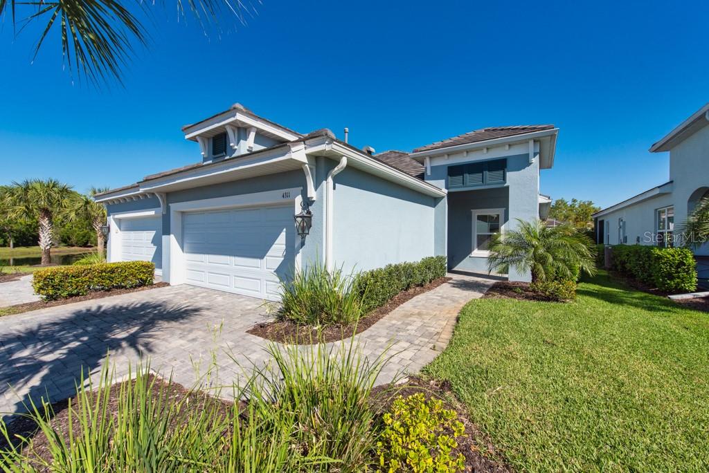 Sun-filled, stylish, and thoughtfully upgraded—this 2022 villa in Poinciana delivers comfort, efficiency, and effortless Florida living in one beautifully designed package. Offering 2 bedrooms, 2 bathrooms, plus a versatile den/office easily suited as a third bedroom, this 1,525 sq ft home sits on a premium lot and showcases over $50,000 in builder upgrades. From the moment you arrive, you’ll appreciate the attention to detail, including impact-rated windows and doors, upgraded gutters, and an extended screened lanai designed for year-round enjoyment. Inside, tile flooring flows throughout, creating a clean, cohesive look. The kitchen is both functional and inviting, featuring quartz countertops, a spacious center island, tall shaker-style wood cabinetry, and stainless-steel appliances—all complemented by natural gas for the range, dryer, water heater, and even an outdoor grill. The open-concept great room is highlighted by an elegant tray ceiling and a statement ceiling fan, seamlessly connecting to the extended screened porch—perfect for entertaining or relaxing evenings. Custom lighting and upgraded ceiling fans throughout the home add warmth and personality. The primary suite offers a private retreat with two generous walk-in closets and a well-appointed en-suite bath featuring dual vanities, an expansive floor-to-ceiling tiled shower, and a separate water closet. Practical perks include no CDD fees and a location that truly stands out. Conveniently positioned in Bradenton, you’re just minutes from shopping, dining, UTC Mall, the airport, Benderson Park, downtown Sarasota, and Lakewood Ranch. Plus, the renowned white-sand beaches of the Suncoast are only a short drive away. A well-designed home with meaningful upgrades in a location that keeps you close to everything. ***FREE 1/0 Rate Buydown when using the seller's preferred lender!***