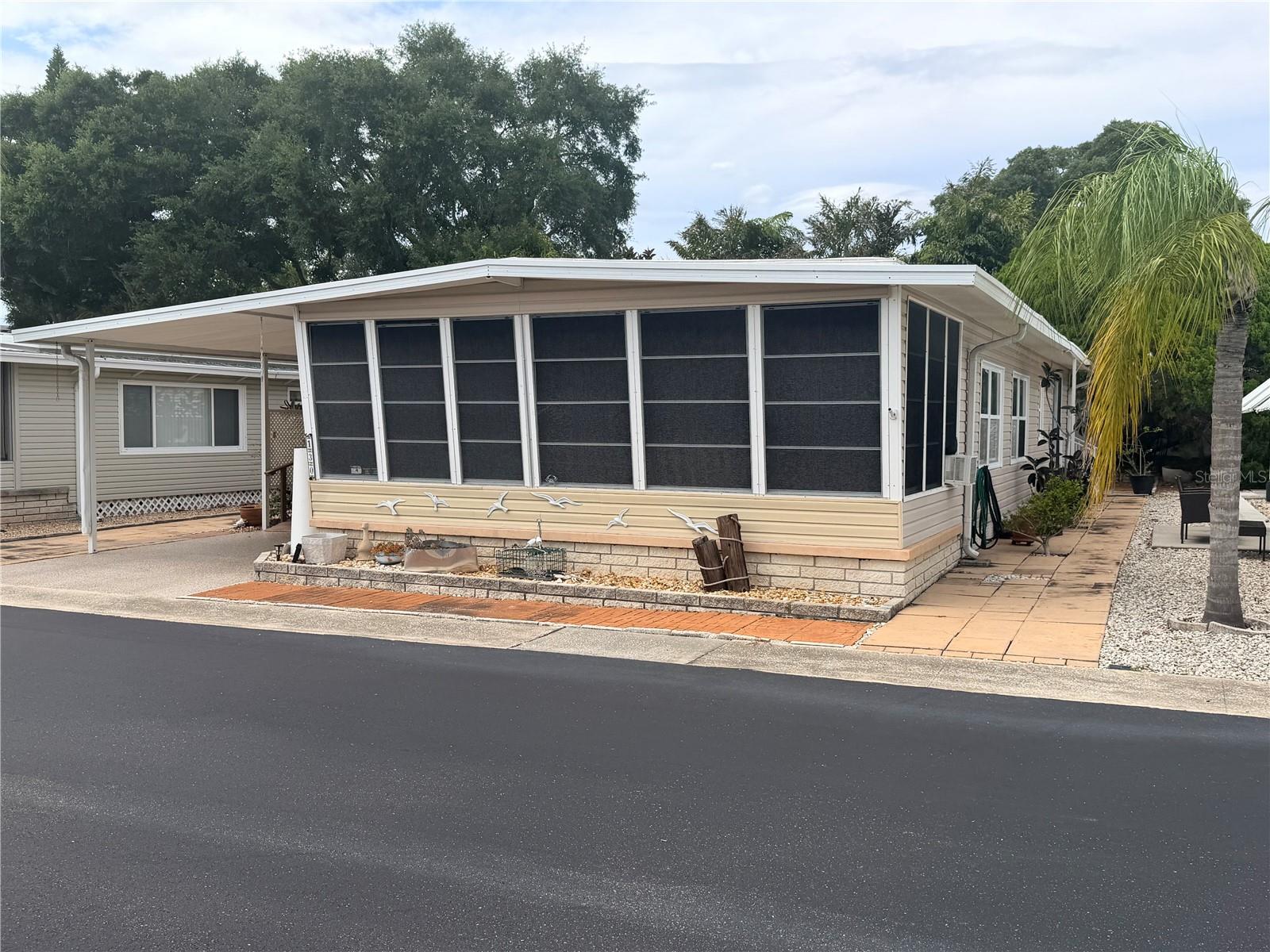 Experience retirement at its best in this beautiful coastal mobile home community.  The home boasts an open floorplan with tons of space for entertaining.  Kitchen updates included engeniered countertops, new cabinets, and a matched appliance set.  The primary bedroom features large closets and a sliding door to a rear outdoor seating area.  The second bedroom includes a built in murphy bed and another sliding door for access to the outside.  The hallway bathroom has a walk-in jacuzzi tub and an updated vanity.  The open dining/living room area is great for entertaining and there are two florida rooms great for evening relaxing.  The home is located in Westwind Resident Owned Community, close to shopping, entertainment, and world famous Honeymoon Island.  The community offers two pools, two clubhouse, a fitness center and multiple recreation courts.  The home includes ownership in the community which gives you a voice and a vote in community affairs.  Schedule your showing today.