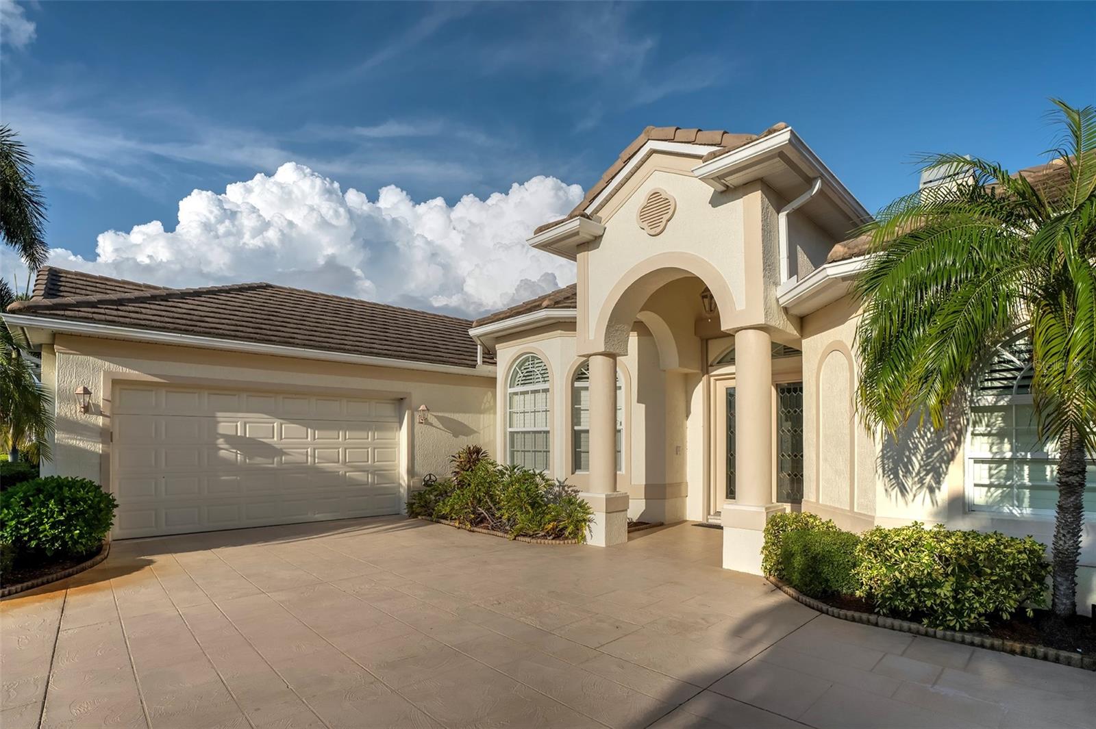 Spacious Estate Pool Home On Premium Lake Front Lot. 2898 square feet of living area well suited for easy living and entertaining. This 4 bedroom, 3.5 bath home with soaring tray and cathedral ceilings features an open living room / family room layout, island kitchen with breakfast bar, central vac, gas fireplace, oversized side-loading garage, split floor pan, large master suite with soaking tub and separate shower,  plant shelves, formal dining area, whole house generator, and so much more. The heated saltwater infinity pool and spa, the outdoor kitchen, the generous sitting area and the gorgeous lake view offer an inviting space to enjoy Florida’s mild winters. Venetia, a well-maintained and centrally located gated community, features a clubhouse, tennis courts, shuffleboard, resort pool & spa, and gathering rooms. The area’s beaches and the historic city center are just a short drive away - shopping & dining possibilities are right around the corner.
