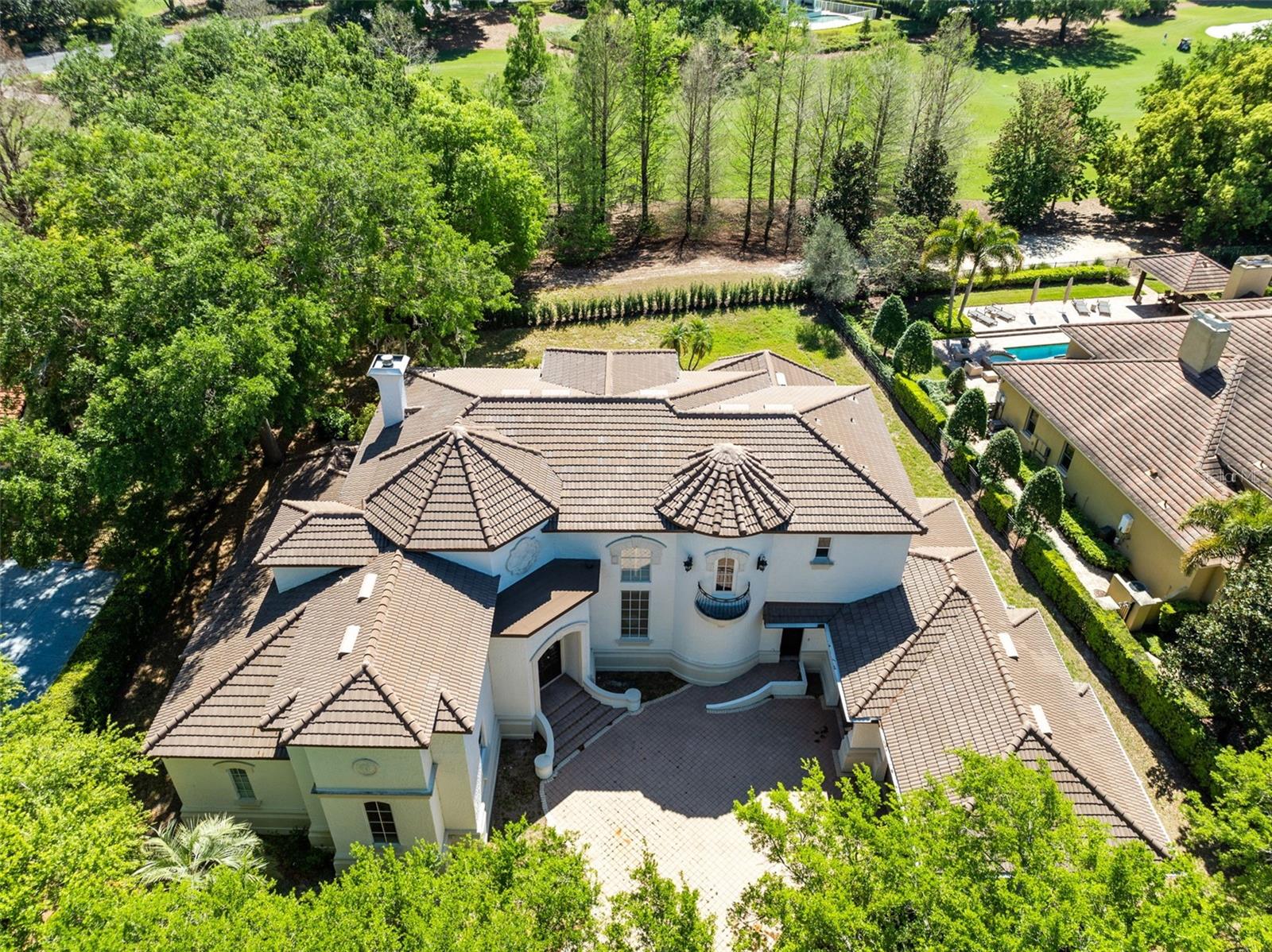 Set along the lush fairways of Isleworth’s exclusive golf course, this Mediterranean-inspired villa blends timeless elegance with an incredible opportunity to create something truly special. Freshly updated with a new roof, newer air conditioning units, most of the windows have been replaced. The home has new paint inside and out, and new wood flooring upstairs. 

Starting at the grand wooden doors and you’re immediately greeted by soaring ceilings in a sunlit two-story living room anchored by a striking stone fireplace. Every detail feels expansive and airy, with travertine floors and natural light flowing seamlessly throughout.

One of the standout spaces is the stunning two-story study—wrapped in rich wood paneling and connected by an elegant wrought iron staircase. Whether you imagine it as a private office, library, or a statement-making lounge, it’s a space that invites both function and style.

On the main floor, the primary suite is designed for indulgence, with a spa-inspired bathroom and a custom walk-in closet. Upstairs, a spacious loft leads to three en-suite bedrooms, giving family or guests privacy and comfort.

The kitchen is a blank canvas waiting to become a chef’s dream, complete with a butler’s pantry and bar area perfect for entertaining or curating your wine collection. There’s even an additional bedroom near the laundry area with the option to add another full bath—giving you even more flexibility to customize this home.

Located in the heart of Isleworth’s guard-gated, golf course community, this home offers not just luxury but lifestyle. Priced to reflect its potential, it’s ready for someone to elevate it into something exceptional and make it their own private retreat.