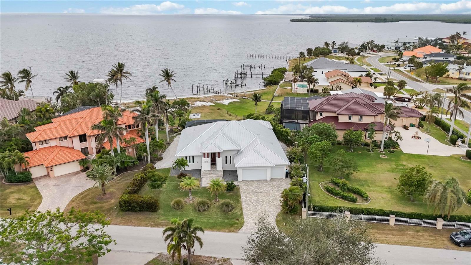 PRICE REDUCED!!Seller relocating to Tampa.
The breathtaking water views serve as a serene backdrop to this exquisite 4-bedroom, 3-bathroom waterfront, gulf access sanctuary with breathtaking, unobstructed views of Charlotte Harbor from nearly every room. This custom-built home built in 2020 offers both construction features and an elevation that were designed to prevent damage from storms. The home is built above flood level, has over-engineered construction foundation and roofing features, Engineered and Built WELL above flood requirements , keeping water out and insurance LOW!
 
No Expenses have been spared in the Well Appointed Waterfront Pool Home featuring Standing Seam Metal Roof, Impact Glass Windows, Aluminum Soffits with 2 ft. overhang for Maximum Sun Protection, Four (4) Bedrooms, Three Full (3) Baths, Attached Oversized Three (3) Car Garage, Travertine Flooring throughout, Solid Wood Cabinetry throughout, Solid Core Interior Doors throughout, Spray Foam Insulation, Volume Ceilings, Open and Bright Great Room with Floor to Ceiling Entertainment Wall with 74"Dimplex Electric Fireplace, 75" LG TV and Bose Soundtouch Soundbar, Zero Corner Doors, Open Kitchen with Expansive Island with Breakfast Bar, GE Profile Appliances, Built in Oven, Induction Cooktop, Stone Counters, Luxurious Private Owners Suite, Separate Den/Piano Room or would make a Great Executive Home Office, Large Laundry Room with Additional Storage. Plantation shutters throughout add a touch of timeless elegance while offering privacy and natural light. Ideal for Entertaining is the Additional Living Space provided by the Spacious Lanai with a newly installed retractable Hurricane Shutter offering additional protection from storms or indoor/outdoor living options, Pre-plumbed Outdoor Designated Kitchen Area with Vent in Place ready for you to Customize your Outdoor Grilling Needs and the Screened Saltwater Pool with new pool heater. Paver Drive and Walkway, there is room on the Eastside of the Home to Park an RV and on the Right side of the Home there is a Custom Rack to Store Kayaks/Canoes. Electrical panel set up for Portable Generator (included with sale). There is a large .5 acre yard and your own Private Sandy Beach, giving you Endless Views and Spectacular Sunsets, plus you are moments to Outstanding Boating, Fishing, and Kayaking. You will be just a Short Drive to the Port Charlotte Beach Complex, Tennis, Shopping, Airports, the Sunseeker Resort, Rays Sports Complex, Dining, Medical, Punta Gorda, Boca Grande, Golf, Pickleball and all that Southwest Florida Offers.
 
Seller has dock plans approved by the Corps of Engineers and quote for future dock available. Seller to include one year home warranty with purchase. We Invite you to schedule a Tour and Make an Offer Today, your Waterfront Lifestyle awaits. Current Homeowners insurance yearly policy is $3250 and Flood Policy yearly is $1847.