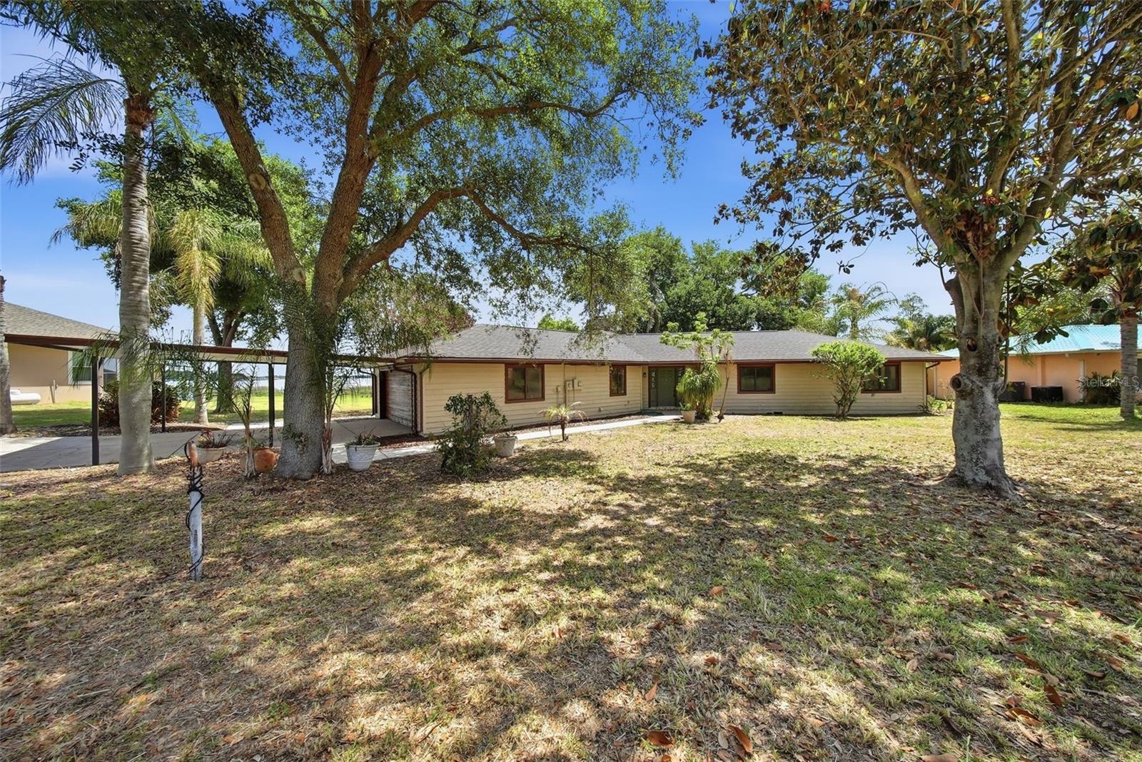 PRICE REDUCED!!! Lakefront Opportunity on Lake Haines – Over 1 Acre with No HOA!
Discover the potential of this charming rustic-style lakefront home located in the city of  Lake Alfred, offering breathtaking views of Lake Haines is part of the 10-Lake Northern Chain in Winter Haven area, directly connected to 9 other lakes via a series of canals. Situated on over one acre of land, this property offers the freedom and space to create your dream home.
This 3-bedroom, 2-bathroom home also includes a dedicated office, spacious living and dining areas, and a cozy fireplace. The interior features high ceilings, beautiful wood beam accents, and a unique circular ceiling design that adds character and warmth. Ceramic tile flooring runs throughout the home.
Enjoy stunning lake views from multiple large windows, a screened-in porch, and a wraparound wooden deck—perfect for relaxing with your morning coffee or entertaining guests. The property also includes a private long dock with covered boat slip, ideal for experiencing true lakefront living.
Additional features include a garage and carport for two vehicles, laundry room, and two storage units. Recent updates include a new roof, new A/C ductwork, some new windows and glass doors, and the home has been recently painted exterior.
The home offers timeless rustic charm and solid construction, presenting an excellent opportunity for a buyer to update and customize it to their own taste.
The highlight of this property is truly the incredible lake views, expansive lot size, and peaceful setting. Also this lot is splittable and you can build your in-laws house next to you.
Conveniently located in Lake Alfred, a growing Central Florida community known for its Chain of Lakes, small-town charm, and easy access to major cities. Enjoy being just a short drive from Orlando and Tampa, with nearby shopping, dining, and outdoor recreation.
Call today for a private showing!!