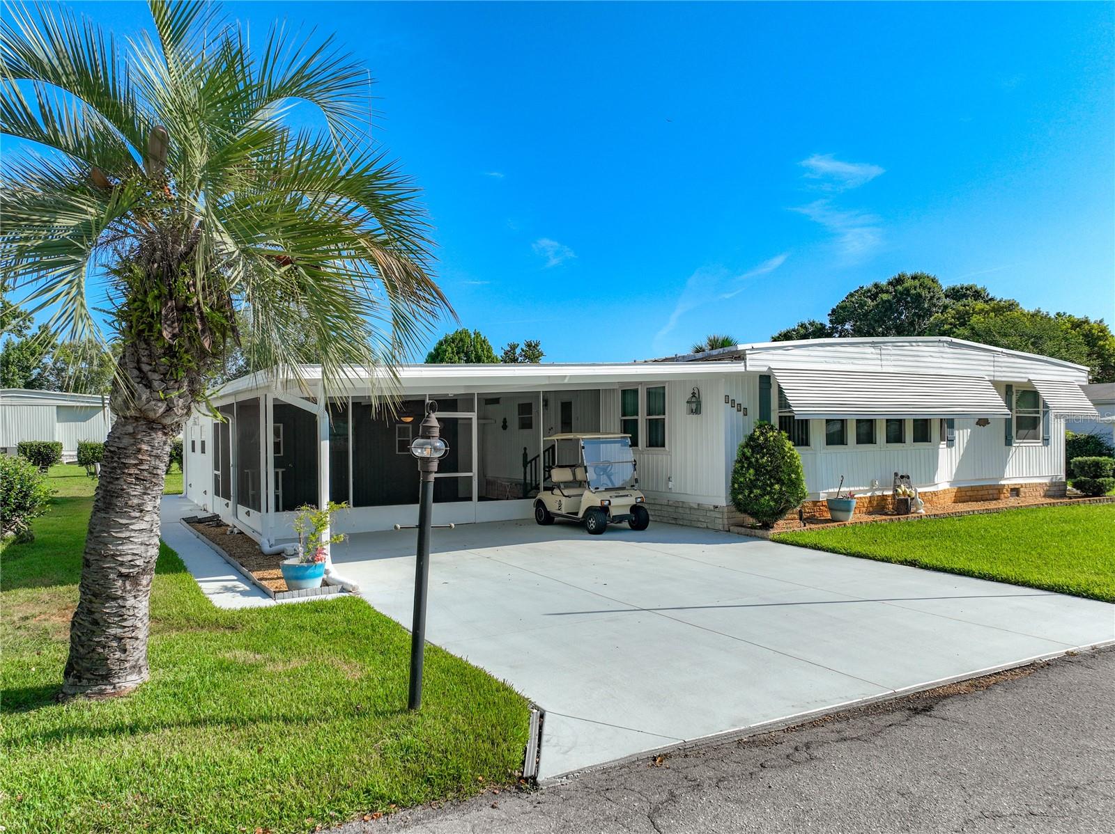 Discover ideal Florida living at Dora Pines... one of the most popular 55+ communities in Mount Dora. This beautifully updated triple-wide manufactured home offers three bedrooms and two bathrooms with a bright, open-concept layout designed for effortless daily living and gracious entertaining. Sunlight streams through generous front windows into the spacious living and dining areas, which connect naturally to the functional kitchen, creating a welcoming heart of the home. The generously sized bedrooms are larger than usual, providing ample space and comfort. The primary suite stands out as a true retreat with its own en-suite bathroom and large walk-in closet, while the additional bedrooms offer flexibility for guests or hobbies. Step outside to the expansive screened porch, a perfect spot for morning coffee or evening relaxation, complete with an attached workshop and a separate laundry/utility room for added convenience. Recent upgrades, including modern bathroom remodels in 2021, bring fresh style and contemporary comfort throughout the residence. This home sits on a larger lot than most in the community, offering extra outdoor space and privacy. The golf cart on site is included! You will love exploring Dora Pines’ friendly streets and well-kept grounds. Located just minutes from downtown Mount Dora’s vibrant shops, restaurants, and picturesque lakeside setting, as well as the exciting new dining and retail options along US 441, this move-in-ready home delivers the ideal combination of peaceful community living and convenient access to everything Mount Dora has to offer.