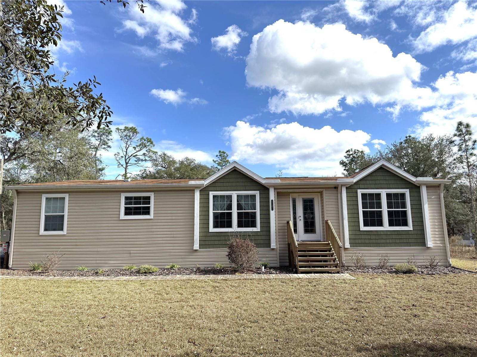 Improved Price TAKE A LOOK---> NO HOA! Meticulously clean 3/2 HOME on 2.41 acres on PAVED road with PAVED driveway. Property is large enough to have an Additional Dwelling Unit (ADU). Reduce your electric bill...this home has Solar Panels!! and R50 insulation in ceiling.  12' x 16' She Shed is insulated, has electric and AC. This Skyline home has many upgrades such as Sheetrock Walls and Crown Molding throughout. Kitchen has Quartz Counters, Pantry, Farmhouse Kitchen Sink, NEW Stove & Refrigerator, lighting under the cabinets and ceramic tile backsplash. Living Room is spacious with vaulted ceiling. Enter the Beautiful Florida Room with its high ceiling and mini split to keep you comfortable all through the year. Primary Bedroom has walk-in Closet and a HUGE walk-in Shower with TWO separate showerheads and a Bench in the ensuite Bathroom. More storage space is in the Laundry Room, and it has a walk-in Pantry/Storage Closet. There is a detached metal carport-shed combo just out the side door. New HVAC in 2023. Seller to give $15,000 CREDIT to buyer.

So much space on this 2.41-acre lot for gardens, animals, firepit, swimming pool, workshop. This comfortable home & land is only 30 minutes from Gainesville. A 40-minute drive will take you to Cedar Key and the Gulf of America. Goethe State Forest is close by for Hiking, ATV riding, or Equestrian Pursuits. Williston is known for Scuba Diving in Blue Grotto or Devils Den.