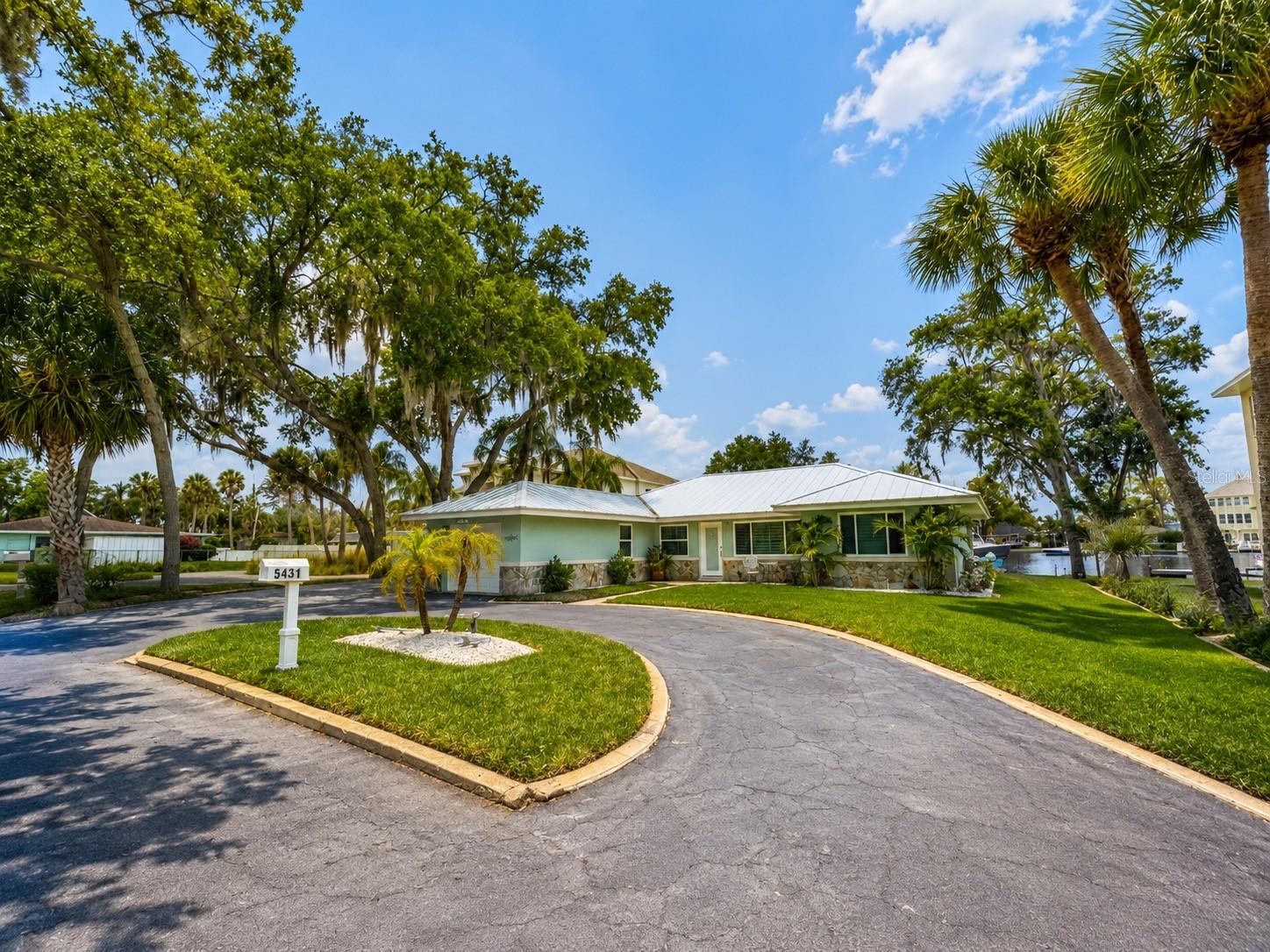 Nestled along the scenic Pithlachascotee River in the desirable North River neighborhood, this beautifully renovated waterfront pool home offers the perfect blend of luxury, comfort, and versatility. Whether you're searching for a primary residence, private family retreat, or income-producing short- or long-term rental investment, this exceptional property delivers.

Tucked away on a quiet side street just off Jasmine Drive, this 3-bedroom, 2-bathroom home features 2,059 square feet of thoughtfully designed living space, 85 feet of pristine waterfront, and direct access to the Gulf within a short boat ride.

From the moment you enter, you’re welcomed by stunning travertine flooring throughout, custom interior plantation shutters on every window, abundant natural light, and breathtaking panoramic river views from nearly every room. The open-concept layout creates an effortless flow between the living spaces, making the home ideal for both everyday living and entertaining.

The beautifully updated kitchen overlooks the water and features quartz countertops, extensive cabinetry and drawer storage, a spacious corner pantry with pull-out shelving, a coffee bar, built-in ice machine, and wine refrigerator. Just beyond the kitchen, a spacious second living area showcases a real wood-burning fireplace, creating a warm and inviting atmosphere with picturesque waterfront views.
The primary suite serves as a private retreat, complete with a built-in electric fireplace, oversized walk-in closet, and spa-inspired ensuite bathroom featuring dual vanities and a large walk-in shower. Two additional bedrooms and an updated guest bathroom with a tub/shower combination provide comfort and functionality for family and guests alike.

Step outside and experience true Florida waterfront living. The expansive screened enclosure features stained concrete flooring, a built-in charcoal grill, sparkling saltwater pool and spa with built-in seating, and plenty of space to relax while overlooking the river. An additional outdoor firepit area creates the perfect setting for evenings under the stars.

Boating enthusiasts will appreciate the private dock and boat lift, installed in 2017, offering quick and convenient access to the Gulf.
Extensive recent upgrades provide peace of mind and modern efficiency, including:
• Dock & Boat Lift – 2017 
• Pool & Spa – 2019 
• Impact Windows & Doors – 2019–2021 
• Screen Enclosure – 2021 
• Metal Roof – 2021 
• Entire Interior Renovation – 2025 
• Brand-New A/C System – 2025 
• Brand-New Pool/Spa Pump & Heater – 2025 
• Custom Flood Barriers – 2025 

Located just minutes from downtown New Port Richey, you’ll enjoy easy access to local favorites including Richey Suncoast Theatre, The Hacienda Hotel, breweries, restaurants, boutiques, art galleries, and the popular Sims Park featuring a splash pad, amphitheater, river walk, playground, and public boat ramp.

This one-of-a-kind riverfront property combines timeless charm, modern upgrades, and an unbeatable location — offering the very best of Florida waterfront living. **One or more photos may be AI generated*