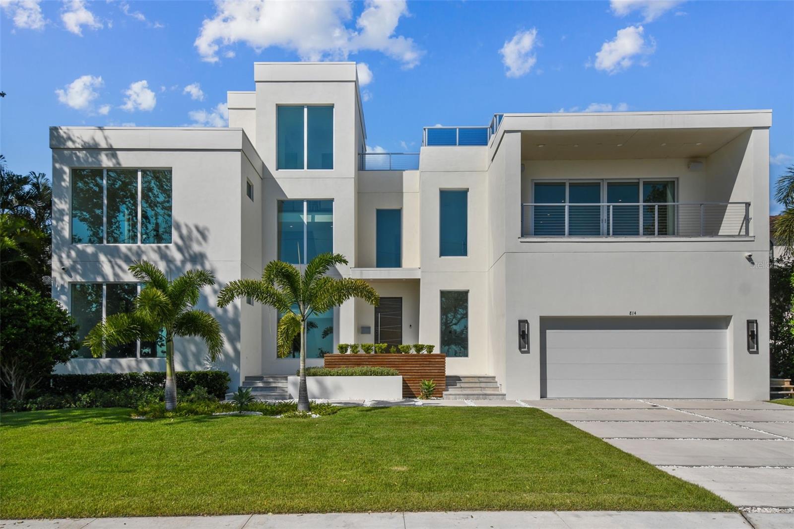 One of a kind architectural design, this contemporary, state-of-the-art, modern masterpiece was built by Forge building Co on a great Davis Islands street. The spacious floor plan was designed for today's active and entertaining driven lifestyle featuring 5 bedroom, 4 full baths and 3 half baths, and a dramatic floating wood staircase. As you enter the home thru the modern pivot door you are greeted with a three sided linear fireplace separating the Family room and dining area. To the right, you will find the open concept kitchen with waterfall center island featuring Calacatta Michelangelo marble countertops and backsplash, highest end Wolf/Subzero appliance package including Subzero wine column, hidden walk-in pantry, with built out drop zone just off the garage. To the left is the huge game/entertainment room, with built-in bar and plenty of room to play pool and watch your favorite ball game. Outside, there is a wonderful lanai living space with outdoor kitchen, lanai level spa, pool half bath, and indoor/outdoor sound system all overlooking the inviting pool. One bedroom and bath are located downstairs. Taking the stairs or elevator to the second floor, you will find spacious halls with plenty of light leading to the 3 secondary bedrooms, one en-suite and one spacious jack and Jill, as well as the spacious laundry room. The master suite is a show stopper, with a custom built bed frame and headboard that stays. Plenty of space to enjoy the views thru the large sliders that lead out to a balcony with vista views over the airport to the water beyond. On the third floor is a half bath and an awesome rooftop deck that can be built out with a full bar. The view from the rooftop will not disappoint. Other features include a Control4 home automation system to control the whole house, in wall and ceiling surround sound in family room and game room, energy efficient spray foam insulation, Trane A/C systems, elevator, 10ft ceilings on all 3 floors, level 5 drywall, wide plank white oak flooring, custom fabricated railings throughout, anodized aluminum windows and doors, and almost floor to ceiling windows in many of the rooms to take advantage of the amazing views. Located on beautiful Davis Islands just across from the walking and bike path and just a short distance away from Davis Islands Village with many restaurants, shops, and bars. Bring your golf cart and enjoy the Island lifestyle with walking / biking paths, baseball fields, public tennis courts, public historic pool, two dog parks, a beach, public marina, and an airport. Additionally, located only minutes from Downtown Tampa, Water Street, Sparkman Wharf, and the Tampa Riverwalk, makes this neighborhood the most desired in South Tampa.