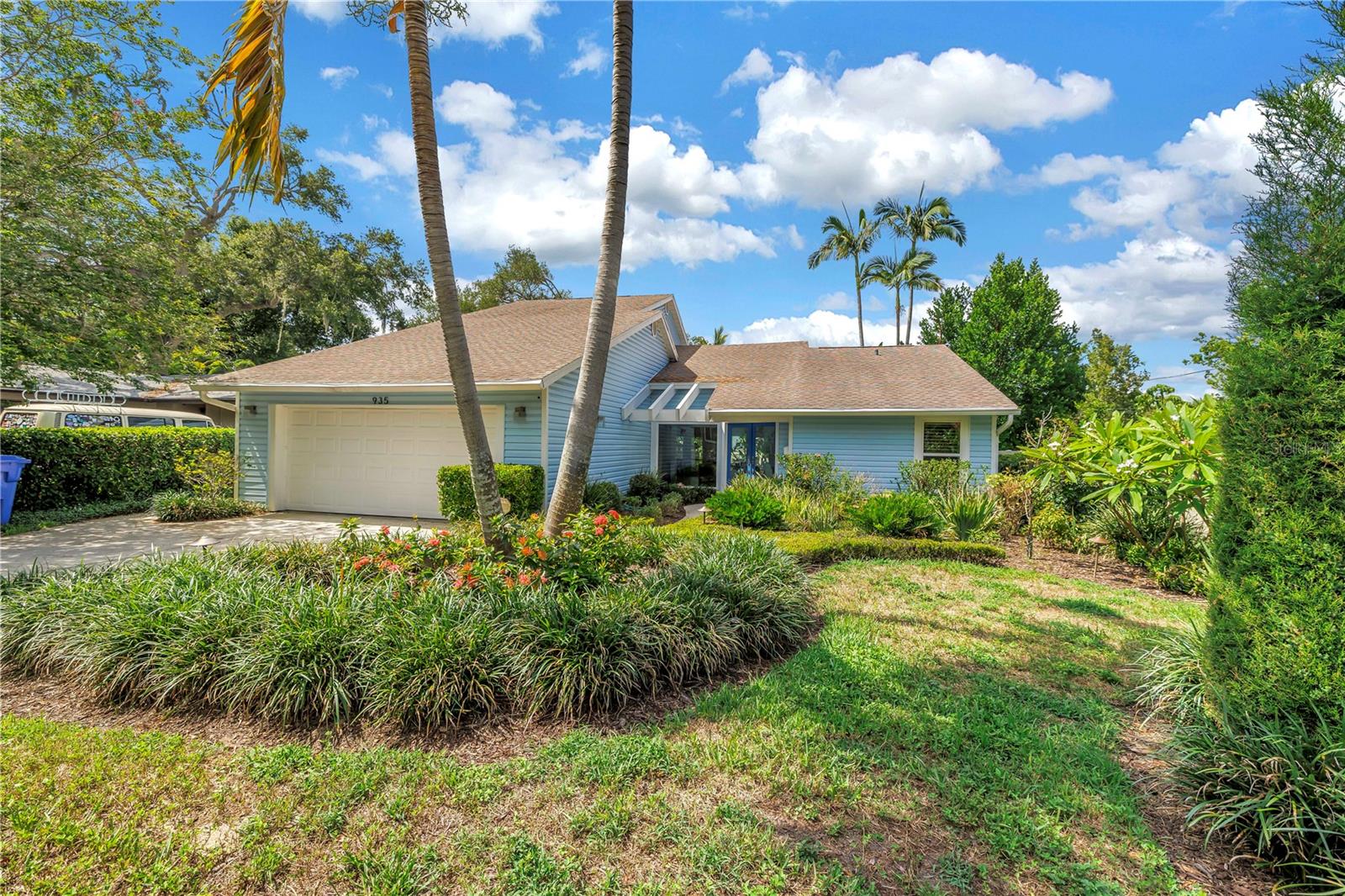 Nestled in the highly sought-after Allendale community, this exceptional three-bedroom, three-bathroom home offers a perfect blend of timeless craftsmanship, luxury finishes, and resort-style living—all in a non-flood zone and just minutes from vibrant downtown St. Petersburg. Designed with an open floor plan, the home is filled with natural light from expansive impact-rated picture windows, sliding glass doors, and transom windows, while soaring vaulted ceilings, recessed lighting, and elegant porcelain tile flooring create an inviting and sophisticated atmosphere throughout. The chef's kitchen is thoughtfully designed for everyday living and effortless entertaining, featuring built-in stainless steel appliances, double ovens, a separate ice maker, a spacious breakfast bar, and a convenient pass-through window to the screened porch. Stunning custom countertops imported from Brazil showcase naturally occurring garnets embedded within the quartzite, making them a true conversation piece. The beautifully renovated bathrooms continue the home's distinctive character, including the guest bath adorned with rare French marble known as "Starry Night," inspired by the artistry of Van Gogh. The spacious primary suite offers walk-in closets and a private covered balcony overlooking the tropical backyard retreat.
Step outside to your own private oasis featuring lush tropical landscaping, low- maintenance turf, a vinyl privacy fence, and a spectacular lagoon-style pool complete with a tranquil waterfall feature and newer pool equipment. Relax or entertain on the flagstone pool patio or beneath the tongue-and-groove ceiling of the screened back porch, creating the perfect indoor-outdoor lifestyle. Additional upgrades include Rain Guard gutters, shutters, a separate upstairs HVAC system, and a spacious two-car garage. Adding an extraordinary touch of history and craftsmanship, the home's custom staircase was handcrafted from a tree harvested from the seller's property in Bethesda. This one-of-a-kind residence combines architectural character, thoughtful updates, and an unbeatable location to create an exceptional place to call home.
