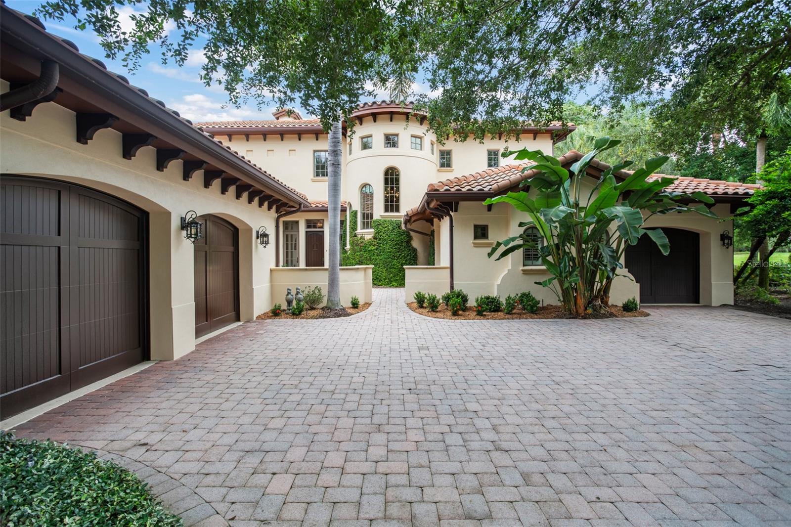 Under contract-accepting backup offers. Located within the Gardens Villas enclave of Isleworth Golf & Country Club, this updated and spacious estate epitomizes luxury living. Offering an impressive 5,695 square feet of meticulously designed living space, this villa presents an exquisite blend of elegance, comfort, and modern convenience, complemented by an array of exceptional features and amenities.The property encompasses five generously appointed ensuite bedrooms, ensuring residents and guests enjoy the utmost privacy and convenience, along with a dedicated office space ideally suited for professionals working from home. The spacious chef’s kitchen is outfitted with high-end Viking, Wolf, and TRUE appliances, abundant storage, a butler’s pantry, and an adjacent entertaining bar designed for effortless hosting. Enhancing both peace of mind and functionality, the residence is equipped with a Moen whole-home water management system, along with a sophisticated home automation and security system that controls many of the home’s key functions. Designed to embrace the Florida lifestyle, the outdoor living spaces are equally exceptional. A private pool and spa, expansive lanai, and fully appointed summer kitchen create the perfect setting for relaxing or entertaining while enjoying the picturesque surroundings. In every detail, this Garden Villa exemplifies the pinnacle of luxury living by seamlessly combining spacious design, refined finishes, advanced smart-home technology, and thoughtfully curated custom features. Whether enjoying the tranquility of the Gardens, entertaining poolside, or working from the comfort of your private office, this residence offers an unparalleled lifestyle of distinction.