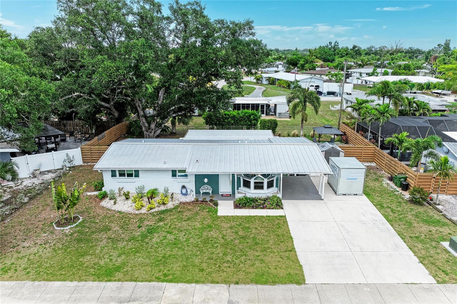 Completely renovated and rebuilt in 2023, this exceptional Sarasota residence offers the perfect blend of modern comfort, quality craftsmanship, and thoughtful design. Every major system and finish has been upgraded, including all new electrical wiring and electrical panel, all new PVC plumbing including PVC pipe to the sewer line, new water supply lines, HVAC system, insulation, and ductwork. The home’s electrical service is also underground, enhancing both reliability and curb appeal.
Designed for both style and durability, the home features a steel roof, hurricane-impact windows and doors, luxury vinyl flooring throughout, recessed lighting on dimmer switches, smoke detectors, and solid-core interior doors. The spacious open-concept layout is filled with natural light and offers generous living and family room spaces, creating an inviting atmosphere for everyday living and entertaining.
The beautifully updated kitchen showcases custom cabinetry, stunning quartz countertops and backsplash, under-cabinet lighting, premium GE Profile appliances, and an impressive oversized single-basin sink that offers both functionality and style. The large family room opens to the backyard through elegant double French doors, seamlessly blending indoor and outdoor living.
The primary bedroom serves as a comfortable retreat with a ceiling fan and a large closet complete with custom shelving. The primary bathroom has been thoughtfully designed with accessibility and functionality in mind, featuring a roll-in tiled shower, grab bars, built-in shelving, a shower light, and both a standard and handheld shower head.
Outside, the professionally landscaped yard provides an attractive and private setting for relaxation and enjoyment. A spacious covered outdoor area creates the perfect space for entertaining, dining, or simply unwinding year-round. The property also includes a convenient carport and a storage shed, providing ample space for parking, tools, equipment, and additional storage needs. The generous lot offers ample room for the addition of a swimming pool, allowing future owners the opportunity to create their own private outdoor oasis.
Ideally located in one of Sarasota’s most desirable neighborhoods, this home is just minutes from Southside Village, Downtown Sarasota, Sarasota Memorial Hospital, Arlington Park, and the city’s renowned dining, shopping, arts, and cultural attractions. World-famous Siesta Key Beach, Lido Key, St. Armands Circle, and Sarasota Bay are all within easy reach, providing endless opportunities to enjoy Florida’s exceptional lifestyle.
With virtually every component replaced or upgraded in 2023, this move-in-ready home offers peace of mind, energy efficiency, and modern convenience in a prime Sarasota location.