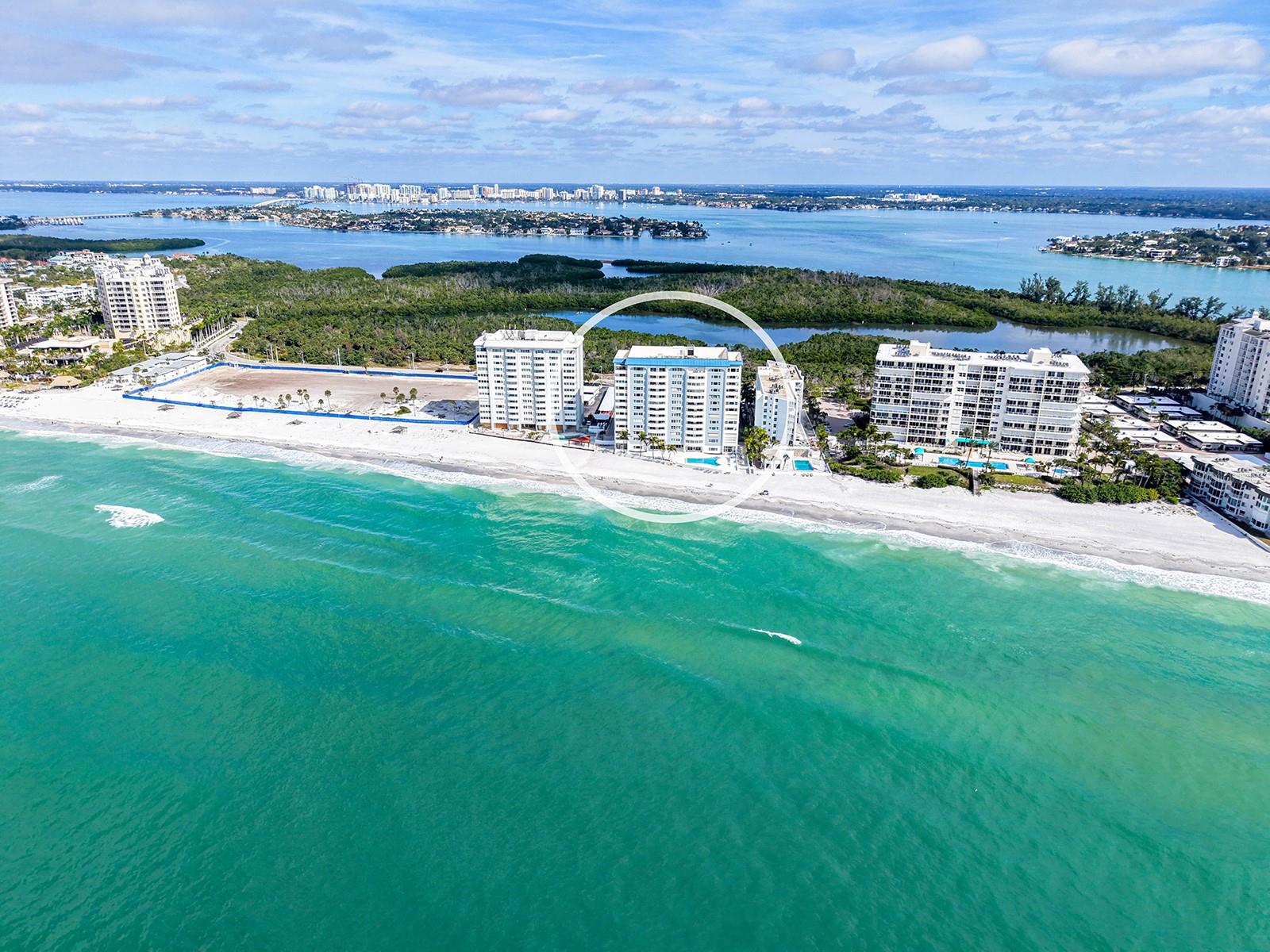 Forever yours the unobstructed views of Sarasota Bay, Ringling Bridge and the Skyline of the City of Sarasota.  Sip your morning beverage while watching the boats go by or dinner and the evening lights of the City.  Beyond $200,000 has been invested to create this thoughtfully redesigned condo in floor to ceiling renovations to create this masterpiece with custom recessed lighting, porcelain flooring throughout, waterfall effect of quartz counters, contemporary sleek cabinetry designed kitchen, European spa-inspired Bathrooms designs and plumbed for your personal washer/dryer.  Enjoy 2035 square feet of contemporary luxury in this light-filled 2-bedroom, 2-bath condominium with a versatile flex room currently used as a bedroom at Key Tower South directly on the soft quartz sands of the Gulf of Mexico on Lido Key.  Expansive impact windows frame daily sightings of dolphins, seabirds, and shimmering water.  Spa-inspired bathrooms feature premium fixtures.  The open-concept floor plan offers excellent flow for entertaining or relaxed everyday living, enhanced by abundant storage and a flexible den ideal for a home office, 3rd bedroom or guest space. The building has recently undergone updates to its common areas, adding a fresh, modern aesthetic that complements the residence. Residents enjoy true beachfront living on Lido Key with immediate access to white sandy beaches and scenic waterfront walks. Just minutes away, St. Armands Circle offers world-class dining, boutique shopping, and vibrant coastal culture. This is a rare opportunity to own a luxury waterfront condo in Sarasota, perfectly positioned for both full-time living and seasonal enjoyment.  Furnishings included with a few personal exceptions.  Washer / Dryer hookup in the hall closet is ready for use.