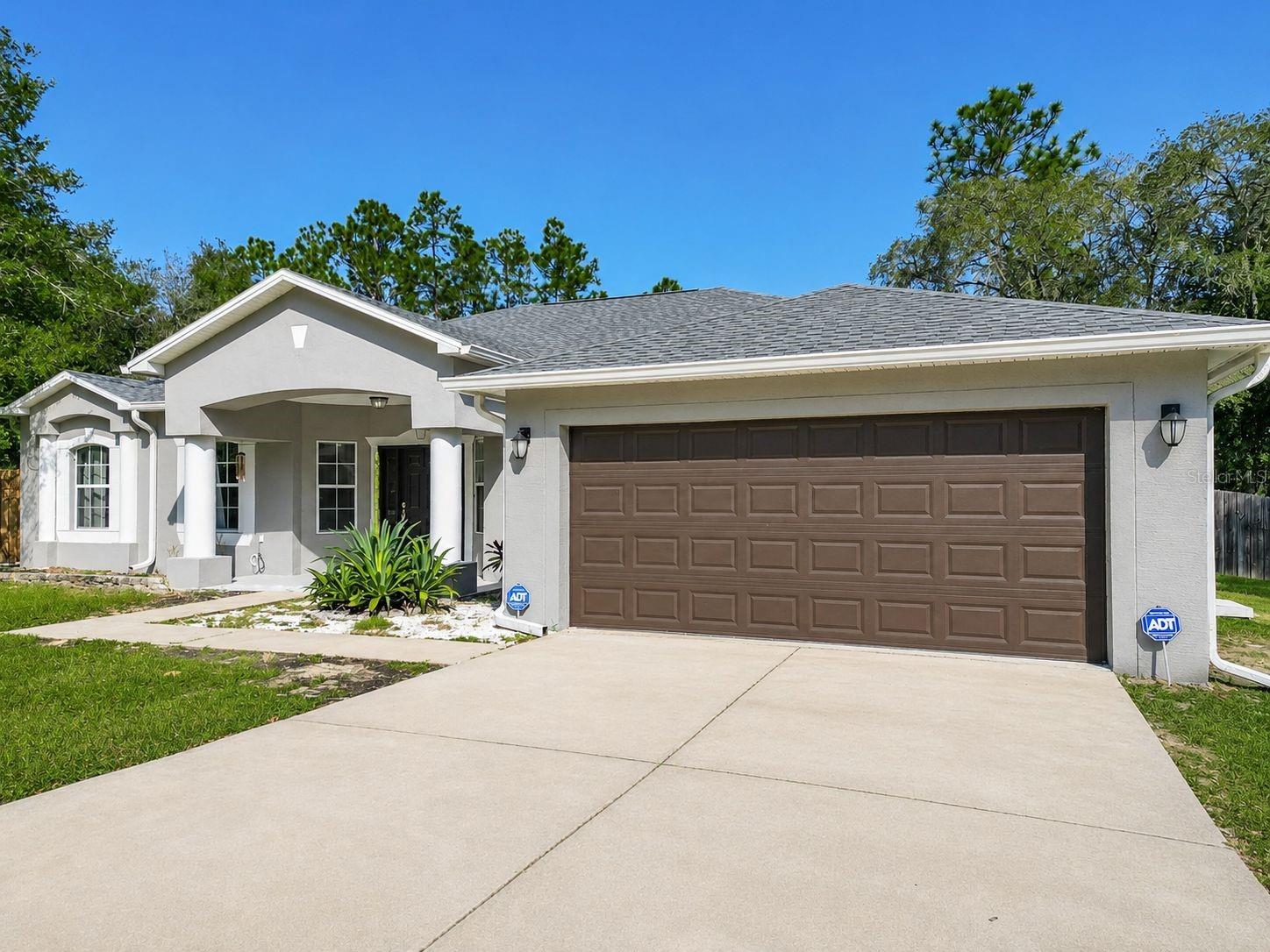 Now offered at $429,900, this thoughtfully updated 4-bedroom, 2-bath home with flexible living space is situated on a spacious 1.52-acre corner lot in Rolling Hills with NO HOA. The bright, open interior features porcelain tile throughout the main living areas, cathedral ceilings, a desirable split-bedroom floor plan, formal dining room, and a versatile flex room ideal for a home office, sitting room, playroom, or hobby space. The kitchen includes stainless steel appliances, solid wood cabinetry, and a breakfast nook overlooking the main living area. Privately positioned behind the kitchen, the generous primary suite offers a walk-in closet and direct access to the covered lanai. Outdoor features add exceptional value, including a 24-foot above-ground pool, private fencing, a 30x40 detached workshop with two separate rooms and its own driveway, a 20x40 RV carport, attached 2-car garage, and additional covered parking for vehicles, trailers, equipment, or recreational toys. Major improvements include a new roof installed in August 2025, HVAC replaced in 2023, and a new hot water tank in 2026. Well and septic help keep monthly ownership costs manageable. Conveniently located approximately 20 minutes from Rainbow Springs State Park and the World Equestrian Center, this property offers peaceful acreage living with easy access to shopping, recreation, and area amenities. Schedule your private showing today and discover the space, versatility, and freedom this Rolling Hills property has to give.