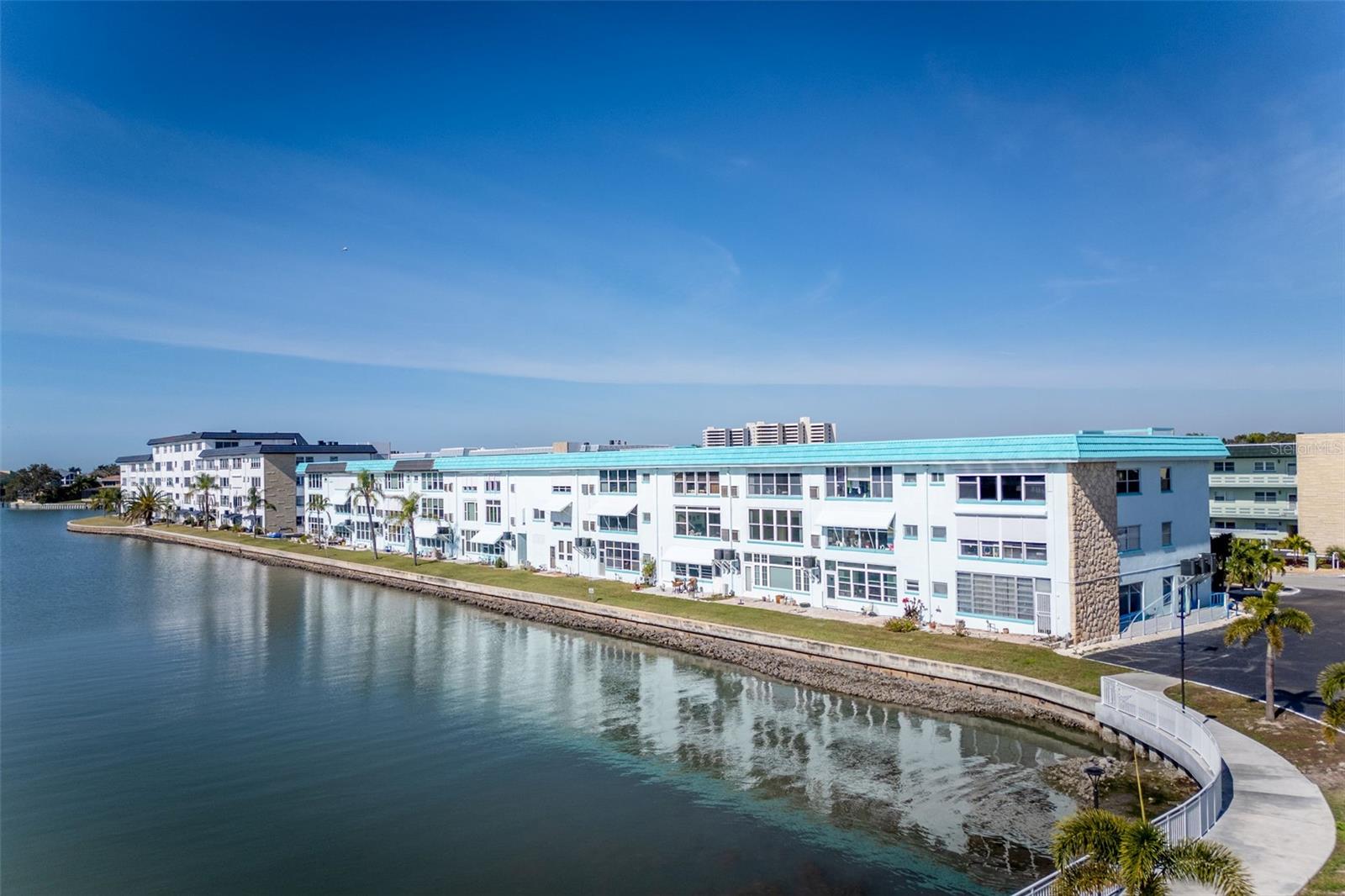 OH MY GOSH!!  PRICE HAS DROPPED!!! Watch sunsets over the marina and see dolphins and colorful local birds from the Florida Room windows of this second floor unit. Light & bright, freshly painted with tile floors in a cool color, the unit is ready for you to move into and make into your own place, decorating in your style. This is the 860 square foot one bedroom, one bath unit. It's close to the elevator and is on the same floor as the laundry room, and extra storage room. You can use any of the four Town Shores heated pools, and spend time at the clubhouse which is equipped with a fitness room, sauna, pool tables and a small library. On the property are tennis, pickleball and bocce courts. The Groton HOA fees include gas for hot water, cooking, and heat, along with basic cable, internet, water, sewer and garbage collection. Nearby you have all the resources of charming, small-town Gulfport with its own beach, weekly market, and a long pier stretching out into the bay. The Gulfport Casino, which is being renovated, and located on Gulfport Beach, offers weekly activities including dances, fitness classes and the celebrated Gecko Ball. there are various excellent restaurants and interesting shops, the Gulfport public library, and so much more. You are also about a 15 minute drive from Tyrone Square Mall, downtown St Petersburg, St Pete Beach, and I275 for easy access to Tampa International Airport, the Tampa Bay Rays games and Tampa Bay Buccaneers games. Carport space #26 is in the first row in front of the building, conveniently close to the building entrance, with additional guest spots on the east end of the Groton.