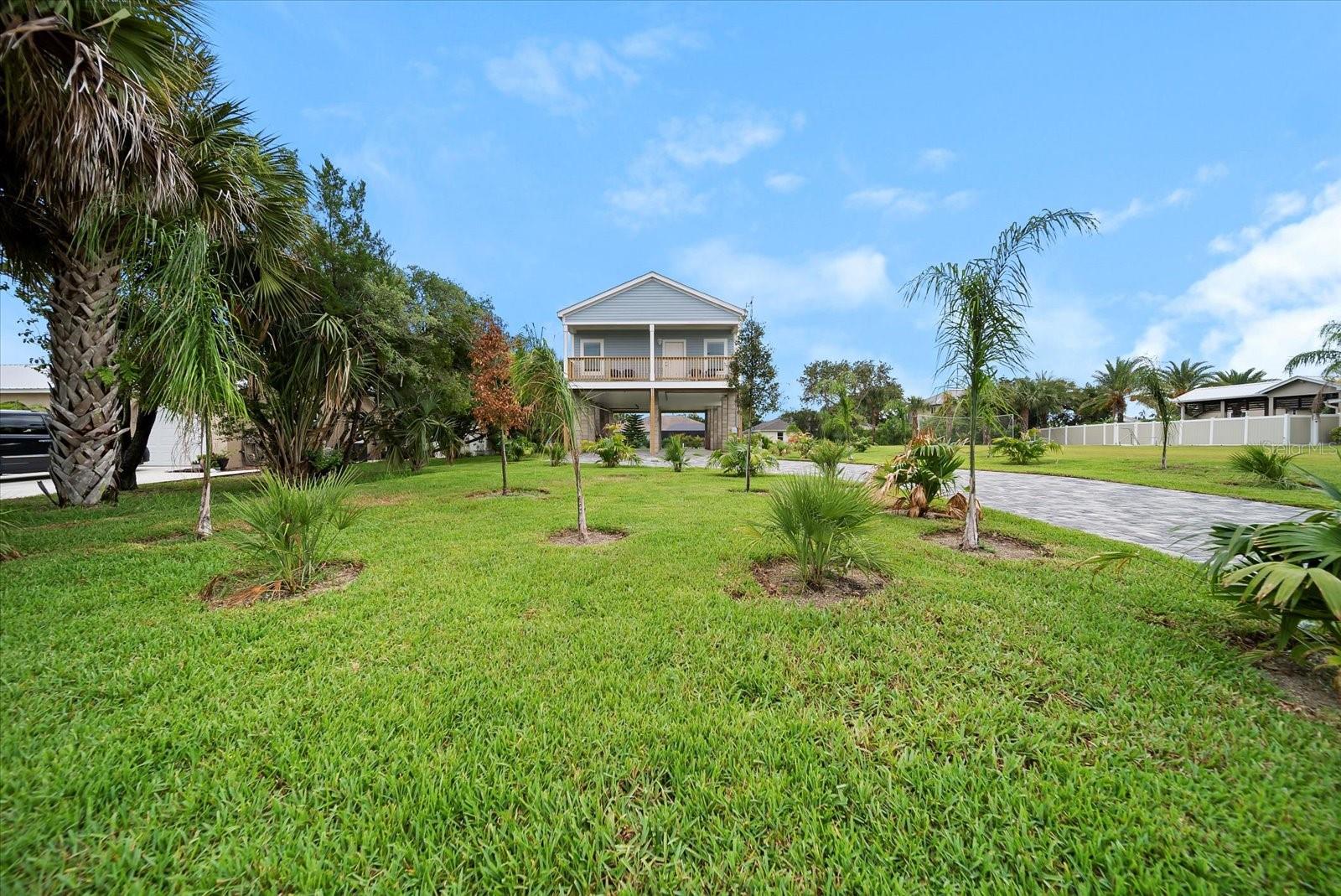 BOATER'S DREAM! Enjoy the ultimate Flagler Beachside, watersport and fishing enthusiast’s retreat. This bright, newly constructed, fully furnished stilt home on a saltwater canal just a short float away from the Intracoastal Waterway. Launch a boat or canoe right from the backyard from your private floating dock and be sure to bring your fishing gear for some of the best fishing Florida has to offer on the Intracoastal Waterway. Gamble Rogers Memorial State Park is just minutes away by boat. The Ocean just 5 blocks east for a quick bike ride or leisurely walk down the street to A1A. The famous cinnamon coquina sands of Flagler Beach are yours to enjoy in this quiet Florida Beach town which also offers trails, parks, water activities and dozens of unique eateries and shops just a short bike or golf cart ride away. Flagler Beach's down to earth, friendly community vibe makes it an ideal location for those who yearn for a relaxing, laid back, Old Florida beach town lifestyle. Need a little excitement? World famous Daytona Beach is just 30 minutes south, and historic St. Augustine is 30 minutes north. The attractions in Orlando are just 90 minutes away. This 3-bedroom, 2-bathroom stilt home offers upper-level living accessed by 2 staircases. Enjoy the canal view from the upper-level deck complete with outdoor furnishings accessed through the sliders from the living area. This home sleeps 8 comfortably. The Master Bedroom is complete with a king size bed and en-suite bath with a deck overlooking the beautifully landscaped yard with paver driveway. The 2nd guest room has a Queen bed, and the 3rd bedroom is outfitted with 2 bunk beds to sleep 4. Bring your boat, kayaks, fishing gear, bicycles and vehicles – it will all fit neatly under the residence, offering covered storage for all the toys and an outdoor shower to rinse off the sand. Located on a secluded street in the midst of all Flagler Beach and the Intracoastal Waterway has to offer, this home is fully furnished and available January 1st. All furnishings are new, high quality throughout. Kitchen: Bring your fresh catch and serve it up here with all stainless-steel appliances, loads of cabinet space and solid surface countertops with plenty of dining space adjacent and at the kitchen island. Fully stocked with all the cookware you'll need to make the most of your stay. Open living space with a large screen smart TV. Full size washer and dryer are tucked away conveniently in the hallway closet. The home has an oversized lot and features professional landscaping with full maintenance and a lovely paver driveway. You won’t have to worry about yard work. Absolutely NO SMOKING indoors, outdoors or anywhere on the property. We love animals but due to allergy concerns absolutely NO pets or animals indoors or outdoors or anywhere on the property. This is a NO PET rental. The home is located on a quiet, safe and secluded street. Guests must also be quiet and respectful. Come and plan an extended vacation or make it yours for a long term lease at this home in Flagler Beach, Florida’s East Coast's best-kept secret.