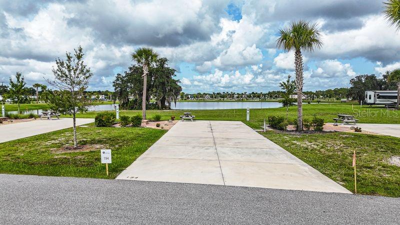 Lot 194 at Resort at Canopy Oaks offers water views and privacy in the rear of the resort, just a short bike or golf cart ride from all amenities. Features include an upgraded paver patio with fire pit, a 20’ x 70’ concrete pad with full 20/30/50 amp hookups, and space for Class A & C motorhomes, fifth wheels, travel trailers, or a small park model — perfect for a seasonal or year-round retreat.
Resort amenities include a tiki bar with live music, pool and spa, putting green, pickleball courts, and beautifully maintained grounds. Use it as a personal getaway or enroll in the resort-managed rental program for potential income. Centrally located in Florida with easy access to fishing, theme parks, shopping, dining, and more.
**Developer incentives are currently available, adding even more appeal to this remarkable opportunity.**

**Developer incentives are currently available, adding even more appeal to this remarkable opportunity.**