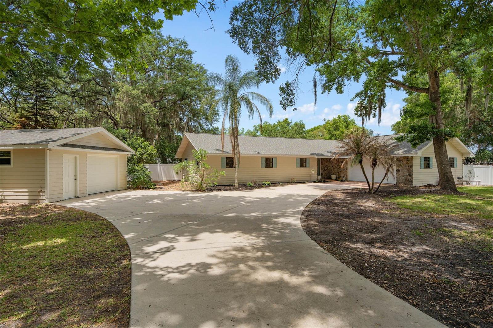 Embrace the tranquility of this fully fenced, one-acre Eustis property featuring 4 bedrooms and 2.5 baths. The home, along with the powered detached workshop, boasts a 2022 roof, giving you lasting peace of mind. Inside, brand-new flooring throughout and an updated laundry room bring fresh appeal. The open-concept living and dining area connects seamlessly to the kitchen and flex space, ideal for gatherings or everyday living. Imagine morning coffee on the intimate side patio or sunset dinners on the expansive screened deck-now a versatile outdoor retreat that invites endless possibilities. The fully irrigated lawn makes caring for the acre a breeze. Nestled close to Mount Dora and Tavares, you'll enjoy peaceful living with space to unwind, while still connected to Central Florida's conveniences.