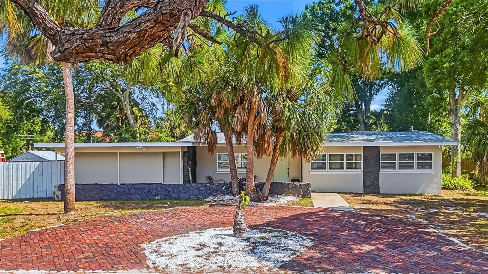 Experience the laid-back Gulf Coast lifestyle in this well-maintained 3-bedroom, 2-bath home with a private heated pool, ideally situated just minutes from the beach. Located directly across from a neighborhood playground and less than 5 minutes to beautiful St. Pete Beaches.
Positioned outside city limits with few restrictions, the home has a proven history as a successful short-term rental, creating an excellent opportunity for investors seeking turn key income, or buyers looking for a personal getaway near the water.

Inside, the thoughtfully designed floor plan centers around a bright kitchen featuring concrete countertops and easy access to the living and dining spaces. Large sliding glass doors bring in natural light and create a seamless connection to the pool area and expansive backyard, making indoor-outdoor living effortless. This spacious home serves as a private retreat with its own exterior entrance, dual walk-in closets, a beautifully renovated en-suite bathroom, and a dedicated laundry area. The outdoor space is equally impressive, offering ample parking, room for a boat or trailer behind an oversized gate, a storage shed, and a fire pit area perfect for relaxing evenings by the pool.