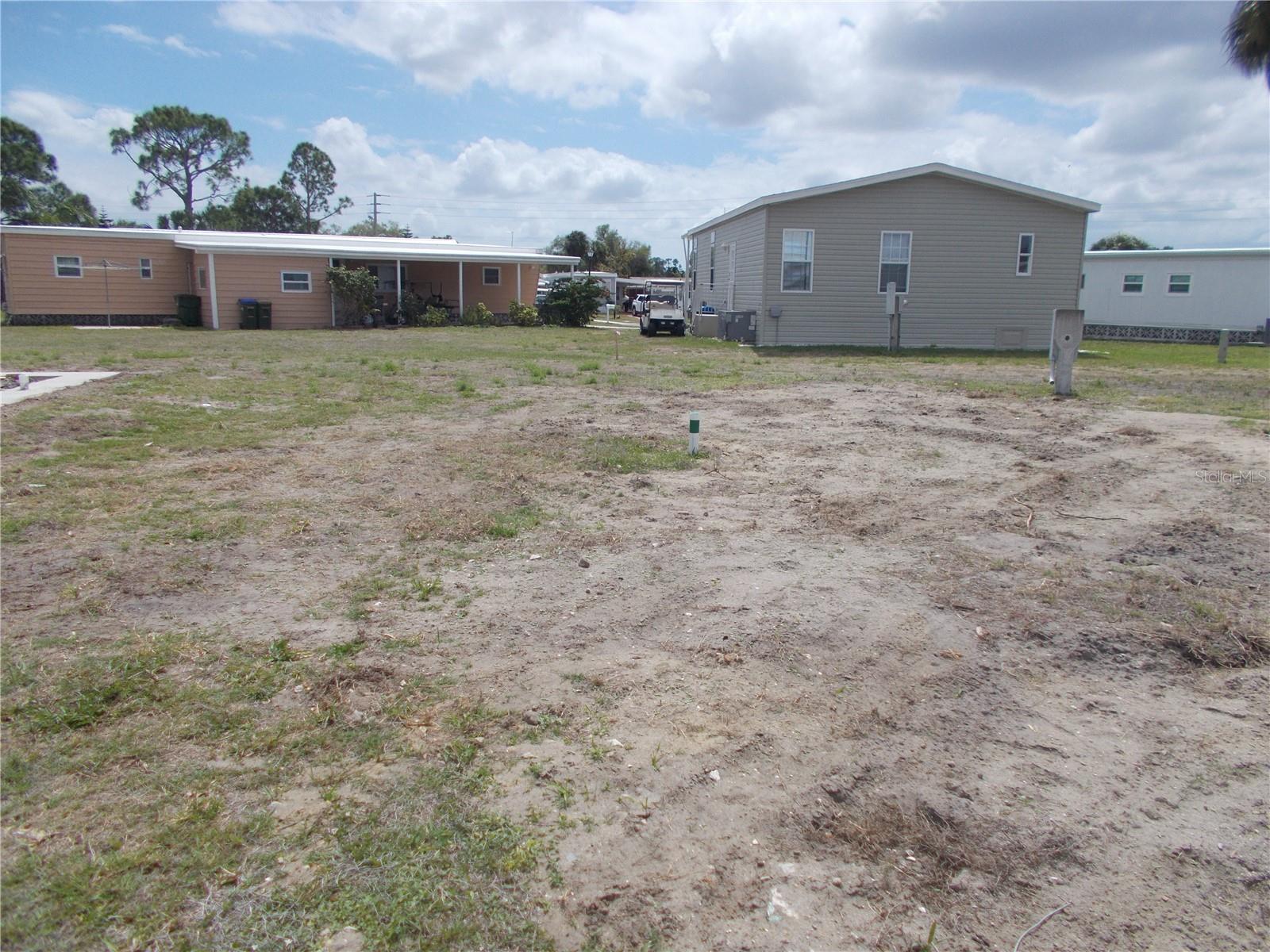 Vacant land in sought after Gated Community of Holiday Park, and in the Pet Section. In Holiday Park you own the land with a deed and the maintenance fee of $195.00 monthly ($2340.00 a year) is included in your taxes. This lot measuring 4918sq ft. is in a cul-de-sac. The driveway has been left. Holiday Park offers many amenities including 2 Pools, Tennis Courts, Pickle Ball, Bocci, Shuffleboard, Laundry, Library, Tennis, Horseshoes, Bingo plus other card games, Fitness Room and so much more. This is a perfect place for your new manufactured home. Come and see