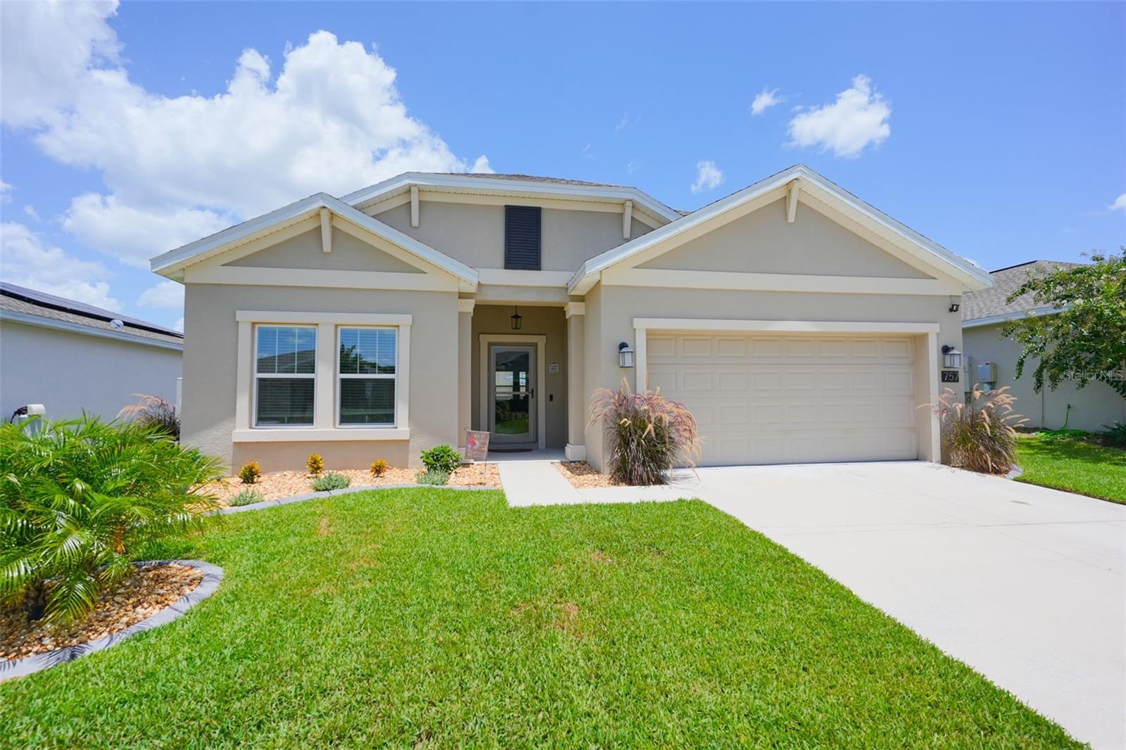 Welcome to 757 Citrus Reserve, a thoughtfully upgraded four-bedroom, two-bath single-family home in Davenport offering a refined blend of style, comfort, and everyday functionality. Professionally enhanced landscaping and a contemporary glass front door create strong curb appeal while bringing natural light into the entry. Inside, the open-concept floor plan connects the kitchen, dining, and living areas, creating an inviting setting for both daily living and entertaining. The updated kitchen serves as the heart of the home with new cabinetry, a farmhouse sink, waterfall quartz countertops, under-cabinet lighting, and durable wood-look plank tile flooring. The spacious primary suite features a large walk-in closet and generous storage, while three additional bedrooms provide flexibility for guests, work-from-home needs, hobbies, or additional living space. Both full bathrooms have been tastefully updated for added comfort and convenience. Outdoor living is a standout feature. The extended screened lanai overlooks a saltwater pool surrounded by pavers and travertine, offering a relaxing space to enjoy Florida living throughout the year. An electric pool heater extends seasonal use, while the fully fenced backyard adds privacy and flexibility. Additional storage and organization include pull-down attic stairs, a plywood-lined attic, garage cabinetry and shelving, and laundry-room cabinetry. A leased solar system may help support energy efficiency, subject to review of the lease terms and utility history. Community amenities are reported to include a pool and dog park. Conveniently located near shopping, dining, and major roadways, this move-in-ready home combines upgraded finishes, practical storage, flexible living spaces, and a private pool setting. Schedule your private showing to experience everything this Davenport home has to provide.