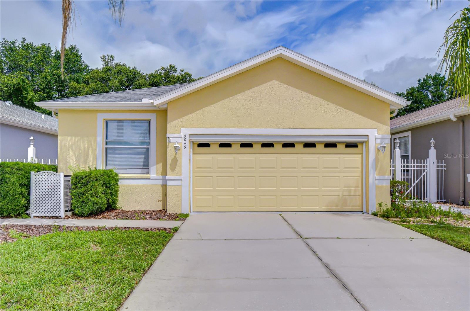 Every detail of this Land O’ Lakes gem is designed for easy Florida living. Nestled within the highly sought-after 55+ gated community of The Groves Golf & Country Club, this move-in- ready 3-bedroom, 2-bath home with a 2-car garage and dedicated golf cart space offers the perfect blend of comfort, convenience, and resort-style amenities.
Surrounded by swaying palm trees, this move-in-ready residence features 1,644 square feet of thoughtfully designed living space. Step through the front gate and follow the walkway to the elegant glass-insert front door with sidelight, opening into a bright foyer accented by ceramic-tiled flooring. A pony wall subtly defines the foyer from the spacious living and dining areas, creating an inviting setting for both everyday living and entertaining. Sliding glass doors open from the dining area to a fully covered, screened lanai with a solid roof, where peaceful wooded views and no rear neighbors create an ideal setting for morning coffee, afternoon relaxation, or evening gatherings.
The kitchen is both stylish and functional, showcasing granite countertops, a breakfast bar, stainless steel appliances—including a French-door refrigerator, smooth-top range, microwave, and dishwasher, a pantry, and a cozy café area illuminated by a charming Tiffany-style light fixture.
The spacious primary suite serves as a private retreat, featuring a generous sitting area highlighted by triple windows, a walk-in closet, and an ensuite bath. Two additional bedrooms, separated from the primary suite for added privacy, offers flexibility for guests, hobbies, or a home office and share a well-appointed second bath with a hallway linen closet. An inside laundry room includes a washer, dryer, and overhead cabinetry. Fresh interior paint enhances the home's move-in-ready appeal.
Golf cart enthusiasts will appreciate the oversized 2-car garage, complete with an automatic overhead screen, dedicated golf cart parking alcove, overhead storage, and a utility wash tub.
Life at The Groves Golf & Country Club means embracing an active, maintenance-free lifestyle within a deed-restricted gated community of 755 homes. Residents enjoy a 15,000-square-foot clubhouse, championship 18-hole golf course, restaurant, heated saltwater pool and spa, tennis, pickleball, shuffleboard, bocce ball, bicycling, fishing, and a full calendar of social events and activities. Stay active with yoga, Zumba, water aerobics, and fitness classes designed for all skill levels.
Ideally located, residents enjoy convenient access to dining, boutique shopping, live entertainment, a movie theater, and the popular KRATE at The Grove outdoor social district. Nearby destinations include Tampa Premium Outlets, AdventHealth Wesley Chapel, and BayCare Hospital Wesley Chapel, with easy access to SR 54, I-75, and the Veterans Expressway for convenient travel to Tampa International Airport and downtown Tampa.
Experience the exceptional lifestyle, outstanding amenities, and welcoming sense of community that make The Groves one of Pasco County’s premier active adult destinations.
Don't miss this opportunity to enjoy the carefree lifestyle you've been dreaming about. Schedule your private showing today and experience firsthand why so many residents are proud to call The Groves Golf & Country Club home. Your next chapter of active adult-style living starts here!