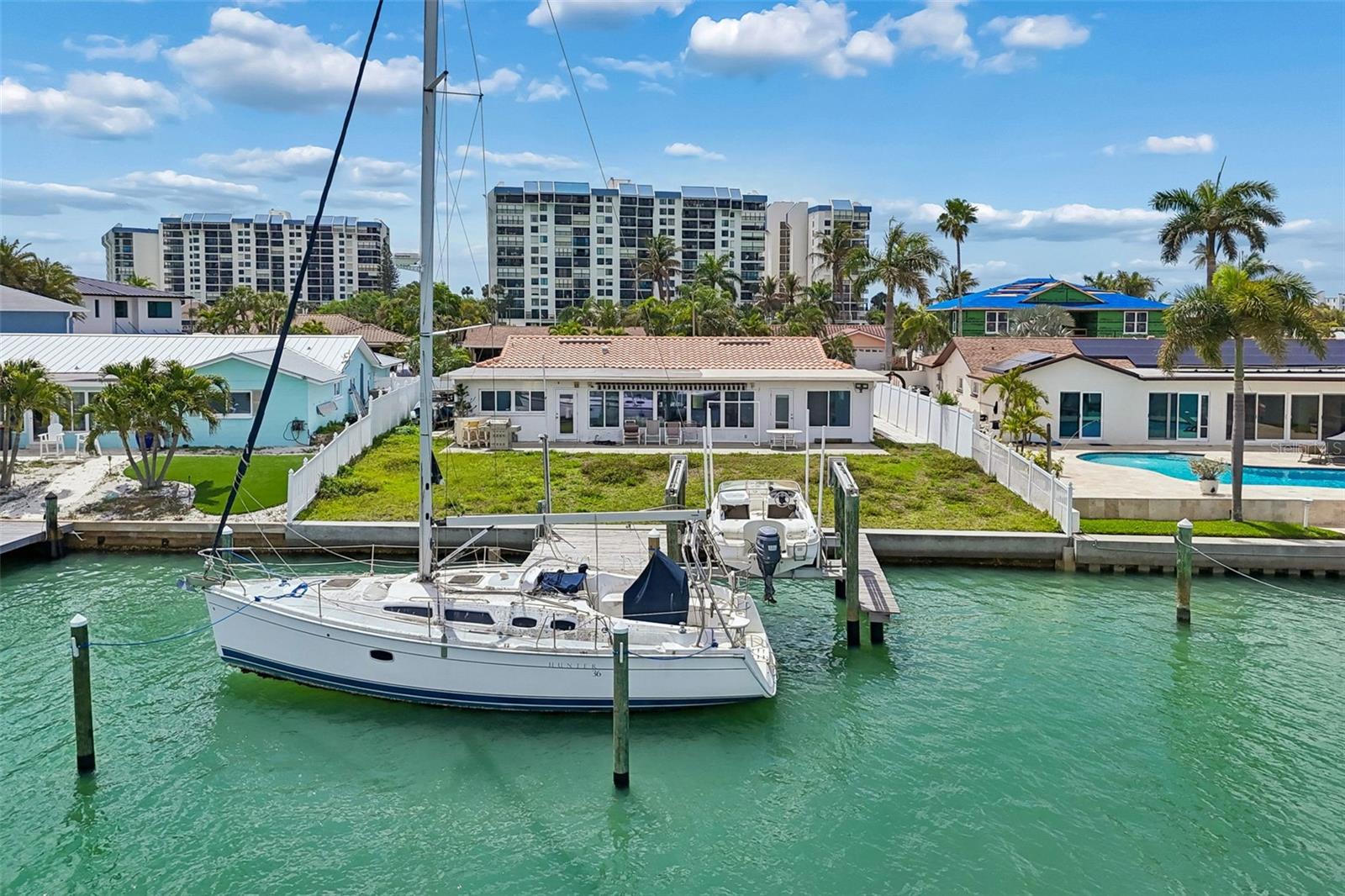 Opportunity meets value on Paradise Island! Located on a quiet cul-de-sac in Treasure Island, this waterfront property stands out with significant recent upgrades already completed, providing a strong foundation for a buyer’s vision. Major improvements include HVAC system updates in 2026 (including ductwork, coil, plenums, and UV system), permitted dock and pilings work in 2026, and sewer servicing and connection improvements in 2026, along with a roof replaced in 2013, A/C in 2019, and a water heater in 2024—offering added value and peace of mind. Boating enthusiasts will appreciate the deep water access ideal for sailboats and a 10,000 lb boat lift, making it easy to enjoy the ultimate Florida waterfront lifestyle. Previously configured as a 3-bedroom, 2-bath home, the property offers flexibility for customization to suit a variety of design preferences. Paradise Island is a highly desirable residential enclave known for its convenience and coastal charm, just minutes from the beautiful beaches of Treasure Island and a short drive to vibrant St. Petersburg with its renowned dining, entertainment, and cultural attractions, plus nearby Treasure Bay Golf & Tennis offering waterfront pickleball, tennis courts, playgrounds, and green space—making this a rare opportunity to create a customized waterfront retreat in an unbeatable location.