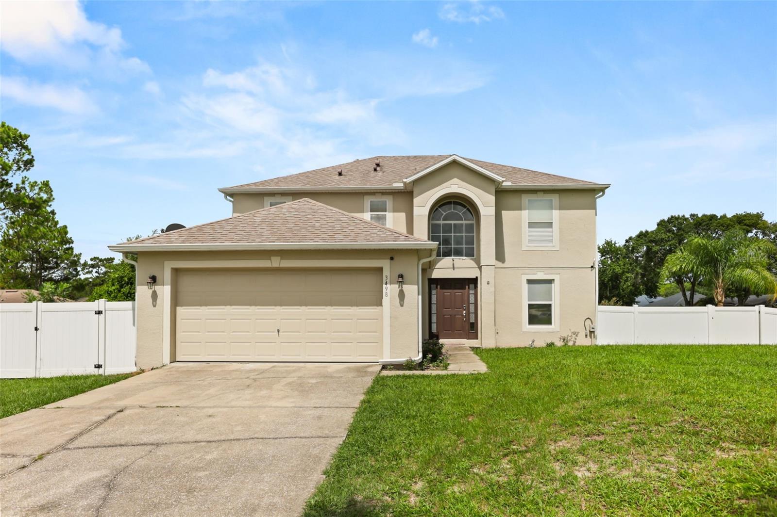 Rare, Massive & Highly Sought-After Oversized Corner Lot!

Welcome home to this spectacular 5-bedroom residence situated on an oversized corner lot with no neighbors on one side, offering exceptional privacy and endless possibilities. This home truly has it all!

Step inside the welcoming foyer where you'll find a versatile first-floor bedroom to the right, a formal living room to the left, and a grand staircase leading you toward the expansive main living area. As you continue through the home, you'll be impressed by the wide-open floor plan showcasing a formal dining area and an enormous family room, creating the ideal setting for holiday gatherings, celebrations, and everyday living. The heart of the home is the beautiful gourmet kitchen, featuring flawless granite countertops, rich wood cabinetry, stainless steel appliances, a stylish tiled backsplash, an oversized deep sink with a premium faucet, and two spacious pantries—perfect for anyone who loves to cook or entertain.

Elegant wood-look tile flooring throughout the first floor, combined with neutral designer colors, gives the home a warm yet luxurious feel.

Upstairs, you'll find the remaining bedrooms, including the spacious primary suite featuring vaulted ceilings, a dual-sink vanity, abundant closet space, and a private ensuite bath designed for relaxation.

Step outside and experience true Florida living in your incredible 20' x 40' fully screened lanai, complete with a hot tub and endless room for entertaining. This outdoor oasis offers limitless possibilities—create the ultimate outdoor kitchen, add additional seating areas, or simply unwind while enjoying your private backyard retreat. There's even plenty of room to add a pool while still maintaining a generous yard.

The oversized fenced yard is surrounded by beautiful white vinyl fencing and provides ample space for your boat, RV, trailers, recreational vehicles, pets, or other outdoor toys.

Conveniently located near SR-44 and I-4, you'll enjoy easy access to Orlando, Daytona Beach, and New Smyrna Beach, making commuting and weekend adventures effortless.

Discover the Charm of Deltona

Nestled between Orlando and Daytona Beach, Deltona offers the perfect blend of peaceful living and modern convenience. Surrounded by beautiful lakes, scenic parks, nature trails, and abundant outdoor recreation, residents enjoy fishing, kayaking, boating, hiking, and breathtaking Florida sunsets.

Families appreciate the welcoming neighborhoods, community events, excellent shopping and dining options, and convenient access to major employers, attractions, and world-famous Atlantic beaches.

Whether you're searching for your forever home, your first home, or a smart investment in one of Central Florida's fastest-growing communities, this exceptional property offers space, privacy, luxury, and an unbeatable location. Don't miss your opportunity to own this one-of-a-kind home!