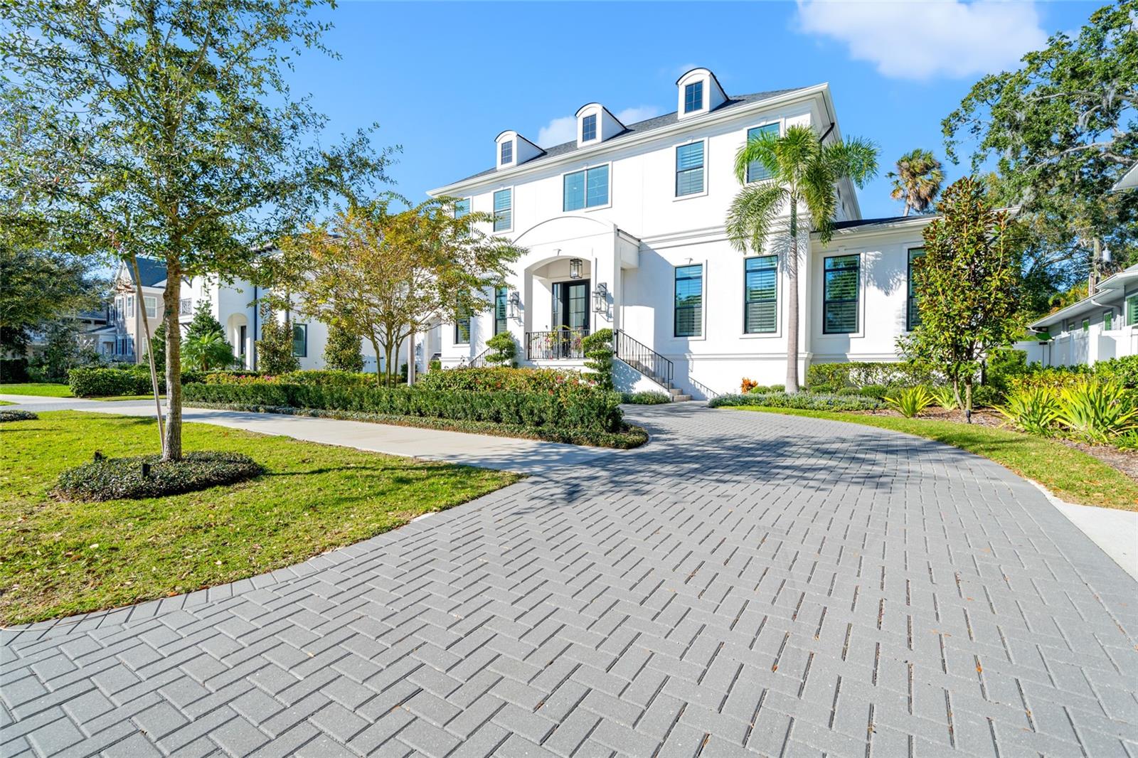 MULTIPLE OFFERS! Welcome to this practically brand new home that was built by the fabulous Taralon Homes. It's their exquisite "Providence" model, a Georgian-inspired masterpiece boasting over 5,600 square feet of architectural splendor. Prepare to be captivated by its show-stopping curb appeal, featuring a dreamy porte cochere that truly sets the tone for the grandeur within. Situated on an expansive 95x128 oversized lot, this palatial home elevates luxury living to new heights. The well-thought-out design showcases not one but two primary suites, one on each floor, ensuring unparalleled convenience and flexibility. The formal living room is a visual delight, adorned with a stunning decorative rock wall and is also complemented with a built-in full-sized wine fridge. Entertain in style within the spacious living area, seamlessly connected to the oversized screened-in lanai. The gourmet kitchen is truly a chef's dream, equipped with exotic granite countertops, a gas Viking stove, wood cabinetry, a pot filler, and a separate Wolf/Subzero Refrigerator and full freezer. Custom and top-of-the-line light fixtures illuminate the space, adding a touch of sophistication. There is crown molding throughout the entire house, as well as coffered ceilings in the formal living room, dining room, kitchen, primary bedroom and bathroom. The The first floor hosts a versatile bedroom currently utilized as an office space, a mudroom with custom built-ins, and one of the 2 owner's suites featuring a walk-in closet, dual vanities, and walk-in shower. Step outside to the sprawling 18x25 foot lanai with a fireplace and TV which will be remaining (along with all the other attached TVs if desired), overlooking the double high screened in privacy-fenced yard with a saltwater pool/spa and a generous outdoor kitchen – an entertainer's paradise. Ascend to the second floor, where an expanded retreat awaits, complete with a larger walk-in closet and a bathroom that rivals most bedrooms. Dual vanities, a makeup vanity, walk-in shower, and a free-standing soaking tub define luxury. The entertainment continues with a 19x19 media/game room with tray ceilings, three additional bedrooms with en-suite baths, and a dedicated laundry room. No detail was spared in this executive home, with plantation shutters adorning all windows. surround sound throughout the interior and exterior, smart home automation systems, and much more. Additional amenities include a grand 2-story formal entry foyer, showcasing recently completed custom molding, and a side-entry Porte Cochere designed for direct access to the mudroom and kitchen. The oversized 2 car detached garage is air conditioned and is accessed through a motor court and also has a full house water filtration system. The house also has a central vacuum system which makes cleaning this home a breeze. Ideally located in the heart of Beach Park, this residence is mere minutes from all that South Tampa has to offer! Tampa International Airport, top-rated schools, shopping, and fine dining all right at your fingertips. Elevate your lifestyle with this exceptional home that seamlessly blends elegance, functionality, and modern luxury.
