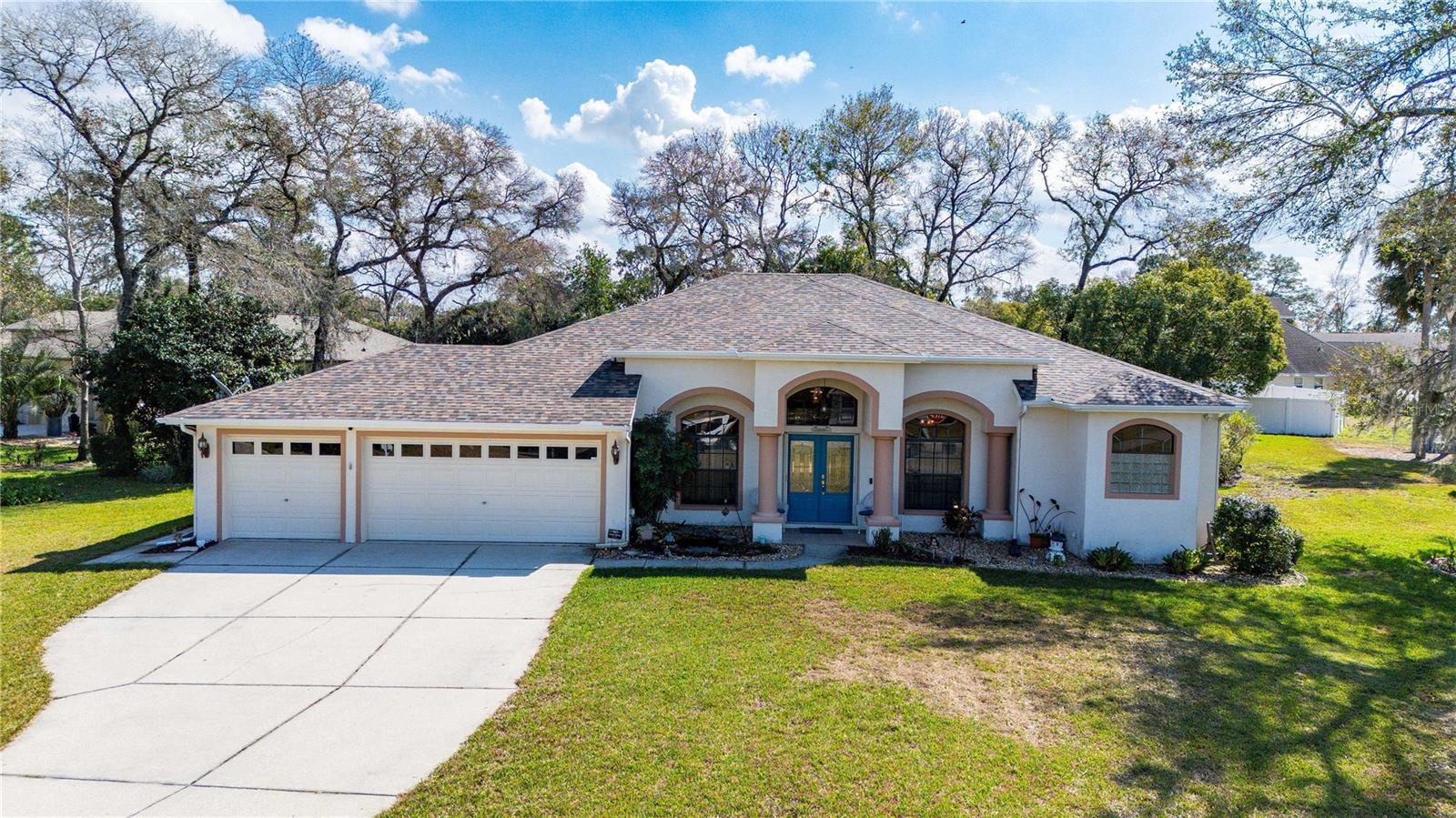 Step into your private oasis in Plantation Estates! Set on a spacious corner lot, this exceptional home blends elegance and comfort with 3 bedrooms, 2 bathrooms, and 2,115 square feet of beautifully designed living space. Step through the grand double doors to soaring ceilings and a thoughtfully designed split floor plan. The great room, highlighted by tray ceilings, creates a warm, inviting atmosphere. A formal dining room and cozy breakfast nook offer versatility for entertaining or everyday life, while a dedicated home office ensures productivity and privacy. The kitchen is a chef's dream, featuring updated appliances, sleek Corian countertops, and ample cabinetry. Unwind in the luxurious primary suite, complete with two spacious walk-in closets and a spa-like en suite bathroom with a soaking tub, dual sinks, and a large walk-in shower.
Outdoor living is just as impressive. Relax on the screened lanai, take a dip in the sparkling pool, or enjoy the lush, park-like backyard with a well irrigation system and an additional storage shed for convenience. A spacious 3-car garage, complete with a water softener and filtration system, adds the finishing touch. Located in a sought-after community with easy access to shopping, dining, and entertainment, this home is a rare find. Enjoy added peace of mind with a new roof (2022) and a newer HVAC system. Don't miss your chance to own this stunning property; schedule a showing today!