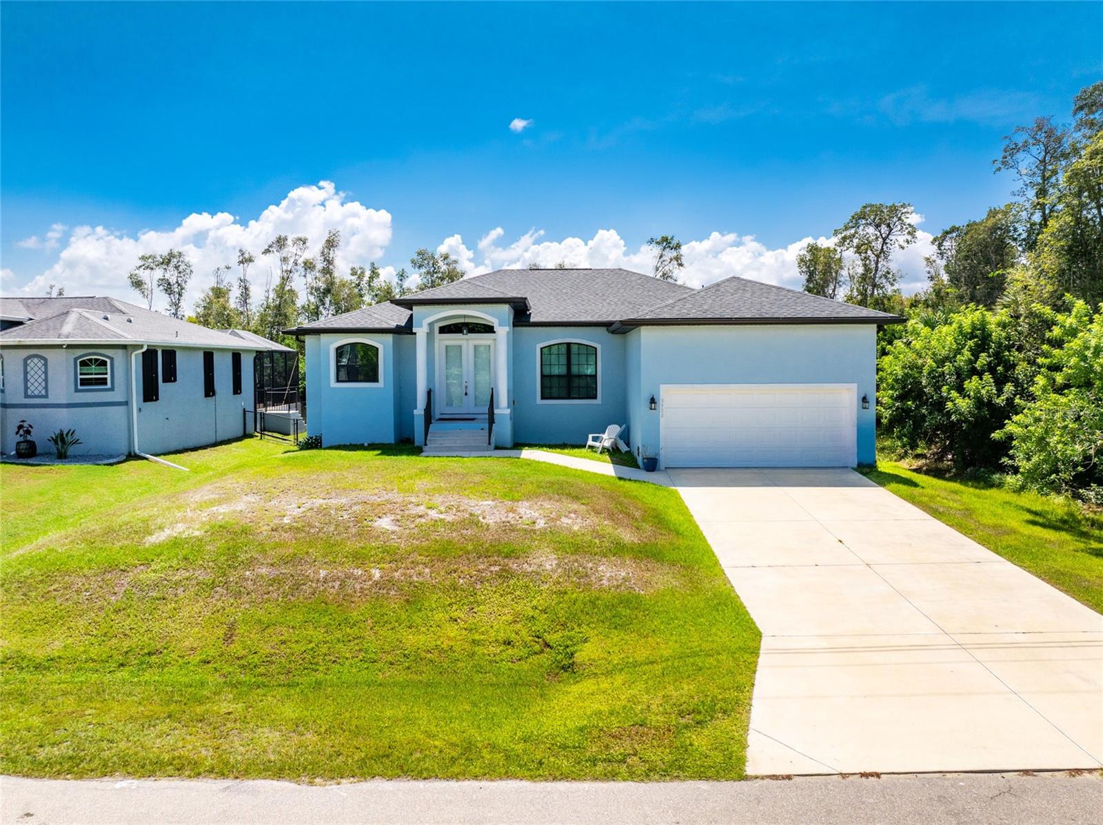 Impressive 3 Bedroom, 2 Bathroom home with attached 2 Car Garage in Punta Gorda. This light and bright home offers an open and split bedroom floor plan with a Great Room, separate Dining Room, well equipped kitchen, laundry room with washer and dryer and screened Lanai. The Great Room has tile flooring, tray ceiling, sliding glass doors to the Lanai and opens to the Kitchen. There is a large window in the Dining Room. The Kitchen features wood cabinets, stone counters, pantry closet, breakfast bar, dining area with sliding glass doors to the Lanai and stainless appliances. Appliances include: French door refrigerator, built in microwave, oven/range and dishwasher. The Master Bedroom suite has two walk in closets, Lanai access via sliding glass doors and private bathroom with dual sinks, stone counters, garden tub and walk in shower. There are two additional bedrooms and the guest bathroom has a tub/shower combination. The large screened lanai overlooks the spacious backyard perfect for your family and pets. Other features include double door entry with transom window. open front porch, tile floors throughout the living areas and carpet in the bedrooms. Convenient to to shopping, dining, events and more!