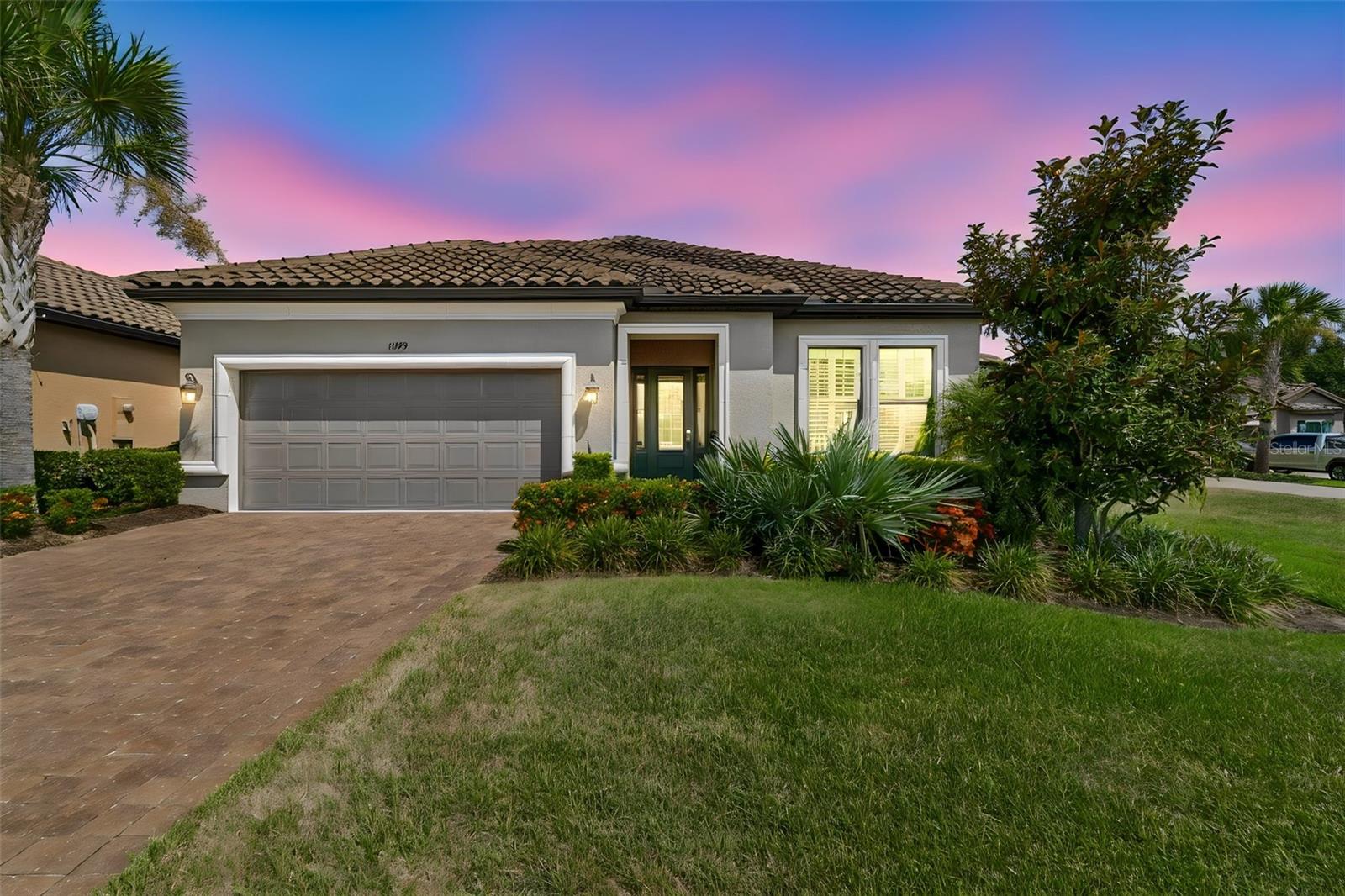 STUNNING and full of value is this Taylor Morrison one-level residence located in the gated community of Esplanade at Starkey Ranch. Situated on 0.21 acres on a cul-de-sac,  watch sand hill cranes, herons, egrets, wood storks and roseate spoonbills walk around the gorgeous POND views. HURRICANE IMPACT WINDOWS/DOORS. Exterior mediterranean style with stone details and TILE roof, immediately catches your eye with the colorful landscaping and well manicured lawn. Fresh exterior paint in 2026. Covered front entrance invites you into this efficient floor plan. Tall ceilings, 8 ft doors throughout, UPGRADED 22" modern style floor tiles throughout- NO CARPET. Ample storage in every room. Beautifully crafted crown molding added to the foyer, living room and primary suite. Bedroom one is located up front with space for a queen bed and has natural light through the picturesque windows. It is conveniently located near a full bathroom with tub/shower combo. Laundry room includes a GE washer/dryer and is accompanied by built-in cabinets, extra counter tops and an extra deep utility sink. Flex room with pocket door is the perfect opportunity to use as an office, den or craft room. Entering the heart of the home, the living room, dining space, and kitchen all open up so entertaining and conversing can be easy. The living room has a floor outlet, the dining space is massive for large get-togethers, and the kitchen has been designed fantastically! REAL WOOD cabinets have been added in a warm traditional color, with soft close, a unique yet modern custom backsplash is in place, Cambria quartz counter tops and MASSIVE center island provides even more storage all around it! Stainless steel appliances, GAS range, microwave upgraded in 2026. Ceilings fans is every room. Surround sound in living space. 
The primary suite is tucked away offering peace and quietness. It has 2 walk-in closets, beautiful window views to the pool, a tray ceilings, and an ensuite for relaxing and pampering yourself. Frameless glass shower doors and jetted tub, dual sinks, and Cambria quartz counters. HURRICANE- PROOF double slider doors open up to your EXTENDED outdoor sanctuary. All screened-in, you have a covered lounge area for relaxing, reading, drinking morning coffee, or whatever your lifestyle calls for. The heated saltwater pool and spa is so inviting. Here you have a built-in shelf, 2 bubblers, and an umbrella holder for shade cover. Gas stub-out for future kitchen dreams. New salt cell and pool pump in 2026 leaves you nothing to worry about. Two car garage is clean and has has a fresh coat of epoxy flooring applied. New garage door springs. Pre-plumbed water softener loop in garage. Lanai and driveway pavers resealed in 2026. The VALUE, convenience, location and possibilities are outstanding for this home. Esplanade provides a clubhouse/fitness center, tennis courts, bocce ball, parks, pool, basketball courts and so much more. Starkey Ranch provides a public library, a district park for sporting events, parks, dog parks, 3 community pools all which Esplanade residents get to use as well! Near medical, grocery, restaurants, shopping and entertainment. A-rated schools to include the Starkey Ranch K8 school. Easy travel to Tampa International & Clearwater International airports. Click on video to view more.