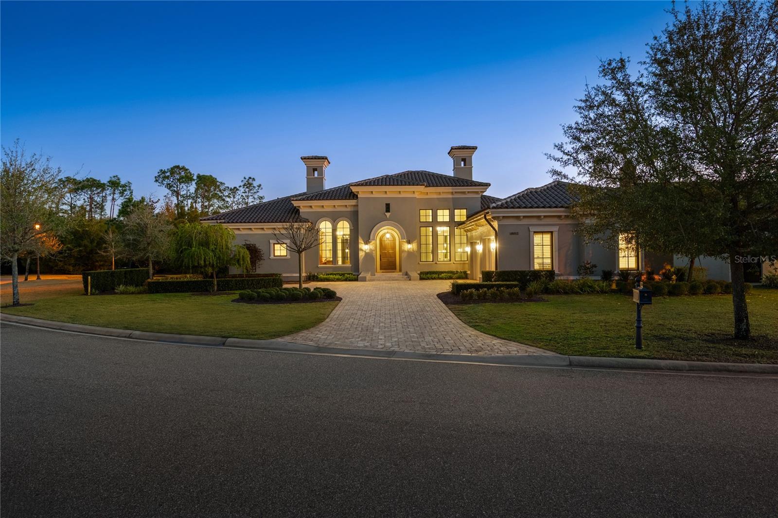 Tucked away on a private cul-de-sac within the ultra-exclusive gates of Golden Oak at Walt Disney World® Resort, this rare single-story estate was originally built by renowned luxury builder Jones Clayton and recently reimagined to feel like a brand-new custom home, never lived in since its transformation. An elegant façade, meticulously manicured grounds, and arched entry create a striking first impression, while uninterrupted sightlines lead to a resort-style outdoor retreat designed for seamless indoor-outdoor living. Inside, elevated finishes and bespoke details define the space. The chef’s kitchen serves as the centerpiece of the home, appointed with top-tier Miele and Sub-Zero appliances, Taj Mahal quartzite countertops, an expansive statement island, custom cabinetry, and an oversized walk-in pantry designed for both everyday living and elevated entertaining. A hidden Mickey mosaic tile feature adds a subtle nod to the magic of Golden Oak.  The kitchen opens to a grand living room with vaulted ceilings, wood beams, and abundant natural light. The primary wing is a true statement featuring a separate sitting room, oversized windows overlooking the pool, and an atmosphere of quiet retreat. The spa-inspired primary bath is expansive and indulgent, complete with a freestanding soaking tub, an oversized walk-in shower, dual vanities, and something that is exceptionally rare within the community, two large, custom walk-in closets designed to rival boutique dressing rooms. All bedrooms are ensuite, including a whimsical Seven Dwarfs-themed guest casita that your guests are sure to love. Outdoors, enjoy a covered lanai with summer kitchen, a resort-style pool and spa, and a detached pavilion with fireplace and water feature. With no left-side neighbor, a three-car garage, mosquito misting system, and even a replica of Walt Disney’s personal office, this home delivers privacy and distinction. Golden Oak residents enjoy access to the private Summerhouse clubhouse and preferred privileges at Four Seasons Resort Orlando, which features an 18-hole Tom Fazio-designed championship golf course, full-service luxury spa, and an extraordinary collection of fine dining experiences, creating a living experience that is as exceptional and refined as the home itself.