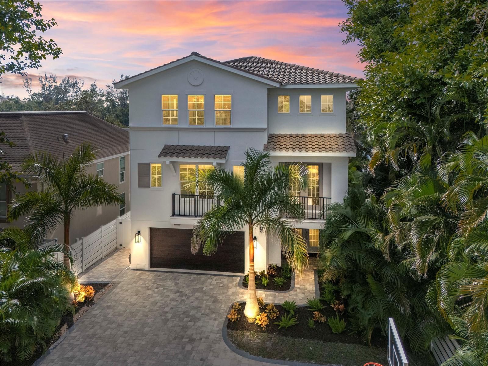 Welcome to the side of Siesta Key most visitors never discover — and many locals refuse to leave.

Located on the peaceful southern stretch of Midnight Pass Road, 8008 Midnight Pass sits far enough from the congestion of the Village and Beach Road traffic, yet only minutes from Crescent Beach and waterfront dining. Here, mornings start with bike rides under a canopy of palms, neighbors walk dogs along quiet streets, and evenings end with sunsets reflecting across Heron Lagoon. This is the residential, laid-back Siesta Key lifestyle buyers search for but rarely find available.

Behind a newly installed private gate, fresh coastal landscaping and a new perimeter wall create a true sense of arrival and privacy. The 2015-built waterfront home has been extensively improved, offering the feel of a newer construction property without the wait, cost, or uncertainty of building on the island.

Inside, the home has been refreshed with new flooring throughout, fresh interior paint, updated stair railings, and designer lighting. A full Sonos surround sound system, Brilliant smart switches, Philips Hue lighting, and an upgraded security system provide modern convenience, while spray-foam attic insulation improves comfort and efficiency year-round.

The completely reimagined kitchen serves as the centerpiece of the home, featuring Viking appliances, quartzite countertops and backsplash, custom cabinetry with under-cabinet lighting, a custom hood, dedicated bar area, and Viking ice maker. The open living space flows directly to expansive sliders overlooking the calm waters of Heron Lagoon — a view that immediately explains why owners love this side of the island.

A flexible den with a custom Murphy bed provides additional guest accommodations, and upstairs guest bedrooms have been enhanced with wainscoting and designer wallpaper. One guest bathroom has been fully remodeled and all bathrooms have been updated with new fixtures and lighting.

Outdoor living is where the property truly shines. The lagoon-front setting offers a kayak and paddleboard launch from your backyard, an IPE dock for fishing or sunset watching, and a revitalized pool area with new equipment and LED lighting. A newly screened upper balcony lanai creates a peaceful retreat above the water, while the private basketball court adds a rare amenity not commonly found on Siesta Key. This is a home designed for those who want Siesta Key without the crowds — boating, biking, paddleboarding, and quiet evenings just minutes from the beach.

8008 Midnight Pass is not just a waterfront property; it’s an opportunity to experience the calmer, residential side of island living while still being close to everything that makes Siesta Key world-famous. Schedule your private showing and experience the difference in person.
