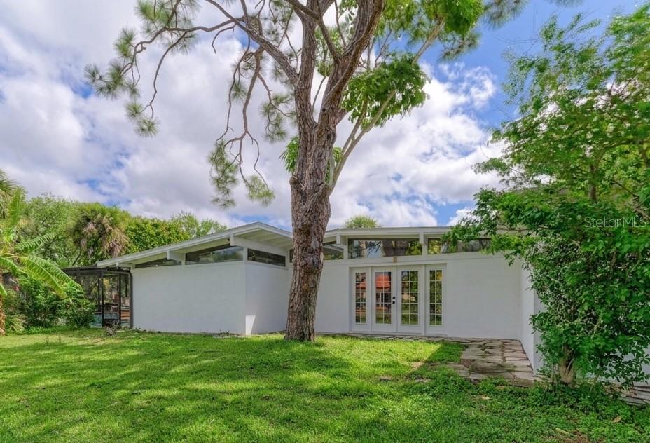 One or more photo(s) has been virtually staged. Don't miss your chance at this rare opportunity: a Venice Island beach house designed by Victor Lundy, a celebrated figure of the Sarasota School of Architecture.  Located just two blocks from the world-famous Venice Beach and turquoise Gulf waters, this spacious mid-century modern pool home on a large corner lot offers the perfect blend of coastal living and timeless style. With genuine mid-century design and huge potential, this architectural gem is a rare opportunity to own a beach-area home within easy walking distance to the Gulf. Inside, you’ll find 3 spacious bedrooms, including two ensuite bedrooms with private baths, ideal for guests or multigenerational living. The home’s midcentury character pairs beautifully with thoughtful updates and modern comforts, including a whole-house water purification system and a new A/C unit (2025). There is NO CARPET anywhere in this home. The main living areas and bedrooms all feature bamboo flooring. Step outside to your private pool oasis, complete with a new pool cage (2025) and a new pool heater (2025)—perfect for year-round enjoyment. There are not one but two additional storage areas located on the backside of the house and one of those areas includes AC. The yard features mature fruit trees, adding charm, shade, and a touch of old Florida to the property. Located just moments from the Gulf beaches and it’s cool breezes, this home also offers quick access to the dining, shopping, and entertainment of downtown Venice, plus parks, bike trails, and other local amenities that make this area so desirable.
Whether you’re looking to move right in and enjoy the beach lifestyle or to create your dream midcentury modern showpiece, this property delivers endless potential in an unbeatable location.