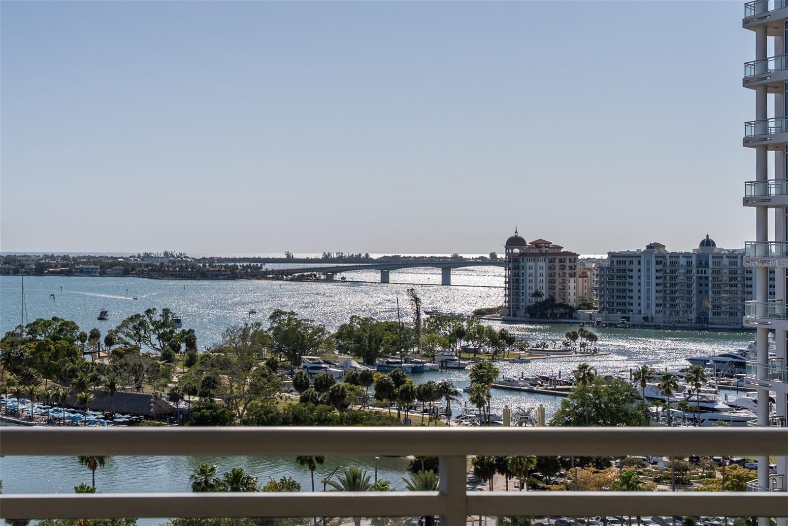 Welcome to the premier offering at the Savoy—an extraordinary, one-of-a-kind penthouse with sweeping Sarasota Bay views, set along coveted, tree-lined South Palm Avenue and rising 11 stories above downtown, where elevated design meets refined living. Fully renovated and expertly designed by the current owner, this remarkable 4,385 sf home offers 4 private terraces and an unmatched indoor-outdoor living experience, all enhanced by seamless smart home integration. From the moment you arrive at your private elevator foyer, you are welcomed by custom glass double doors with genuine leather handles, set against a striking backdrop for the owner’s curated Chihuly glass collection. At the heart of the residence, the chef's kitchen is both striking and functional, appointed with Poggenpohl push-and-pull cabinetry, Wolf double ovens, Subzero refrigerator, Miele induction cooktop with gas burner, Miele hood, an impressive 5-inch granite island with breakfast bar, a matching granite dining table, and beautiful bar with Subzero wine refrigerator. Imported Italian porcelain tile flows throughout, creating a cohesive and sophisticated backdrop for everyday living and entertaining. Rich suede finishes, bespoke lighting throughout, custom wall coverings, and expansive walls of glass define the interiors, bathing the home in natural light while framing breathtaking panoramic Bay and City views from every angle. Designed for effortless entertaining, the top-level expansive newly tiled terrace is the perfect spot for cooking on your gas grill and enjoying all fresco dining and the sweeping skyline vistas. The serene and spacious primary suite features a spa-like bath with his and her vanities with integrated smart mirror TV displays, custom mosaic tile, tile and glass shower, and free-form 2 person Jacuzzi tub with air jets where you can relax and take in the incredible view. Guests enjoy a private and sumptuous guest suite with en-suite bath which easily functions as a second primary suite. The 3rd bedroom is currently used as an office with high-end custom built-ins perfect for productivity. The spacious living and family rooms both feature media centers with rich piano-gloss wood paneling. The smart-home residence features modern conveniences which elevate daily living such as custom walk-in closets with sensor-activated lighting, integrated motorized window treatments, automatic lighting and whole home Sonos audio, and is equipped with three A/C units, new digital Essency water heater, and Aquasana whole house water filtration system, ensuring comfort and peace of mind. Rare private 3 car garage with EV charger with 1 section that has been enclosed and air conditioned. Residents of the 24-unit Savoy enjoy an array of upscale amenities, including heated lap pool and spa, concierge and full time on-site manager, guest suite, towel service, locker rooms with sauna, a dog run, grilling area and catering kitchen, building water softener, secure parking, and elegant gathering spaces designed for hosting and connection. Located just steps from Sarasota's Main Street, Burns Court, the Bayfront, and Selby Gardens, this exceptional penthouse offering simply cannot be replicated.