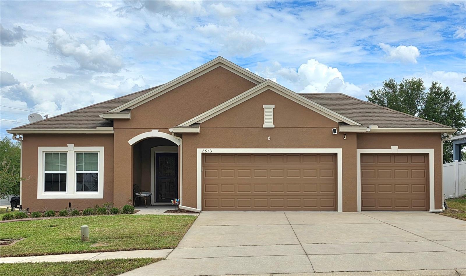 Welcome to this beautifully maintained 4-bedroom, 2-bathroom residence perfectly situated on a corner lot in the sought-after Grand Island Reserve. Built in 2013 and spanning over 1,800 square feet, this home offers a thoughtfully designed split-bedroom floor plan that maximizes both privacy and open-concept living. The heart of the home features a spacious kitchen that flows effortlessly into the main living areas, ideal for hosting gatherings. Retreat to the primary suite, which boasts a generous walk-in closet located in private en-suite bath. Smart thermostat manages energy efficiency and comfort. Smoke and carbon monoxide detectors recently updated. A standout feature of this property is the dedicated golf cart garage, providing the perfect solution for extra storage or Lake County leisure. Outside, the corner homesite offers enhanced curb appeal with refreshed paint completed in November 2024, and a sense of space rarely found in standard lots. Experience the quiet charm of Grand Island while staying minutes away from the shopping, dining, and waterfront recreation of nearby Eustis and Mount Dora.