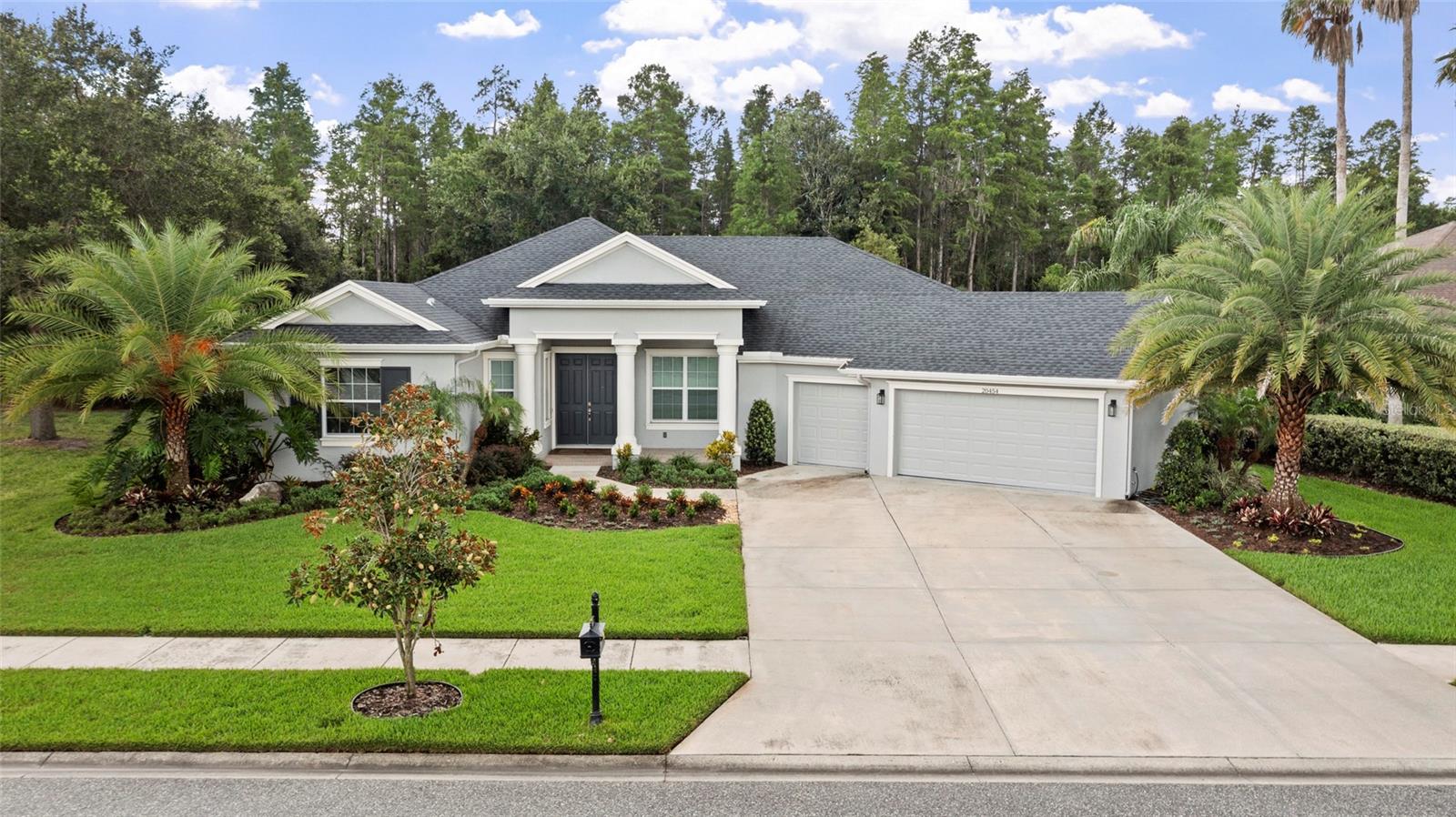 Virtually Staged. Nestled on a nearly one-third-acre homesite in the exclusive gated enclave of Rose Pointe in award-winning Connerton, this stunning Avalon Building Corp. home offers 3,077 square feet of thoughtfully designed living space with 4 bedrooms, 3 bathrooms, a private office, and a spacious bonus room. This is the latest version of Avalon’s two-time Grand Award-winning floor plan, featuring bright, open living spaces and exceptional craftsmanship throughout.
Double entry doors welcome you into an elegant foyer leading to a formal dining room with a double coffered ceiling, crown molding, and sliding glass doors to the lanai. The luxurious primary suite features a coffered ceiling, dual walk-in closets, lanai access, and a spa-inspired bath with dual granite vanities and a frameless glass walk-in shower. The gourmet kitchen boasts granite countertops, stainless steel GE appliances, 42-inch cabinets with crown molding, and a large center island overlooking the spacious family room with triple sliding glass doors showcasing peaceful conservation views.
The versatile bonus room with an adjoining full bath offers endless possibilities as a media room, home gym, office, or private guest suite. Enjoy a large backyard with room for a pool and beautiful natural surroundings.
Connerton residents enjoy resort-style amenities including a clubhouse, pool with water slides, fitness center, tennis, basketball and volleyball courts, miles of walking and biking trails, a café, and year-round community events. Conveniently located near SR 52, SR 54, the Suncoast Parkway, I-75, shopping, dining, and more.