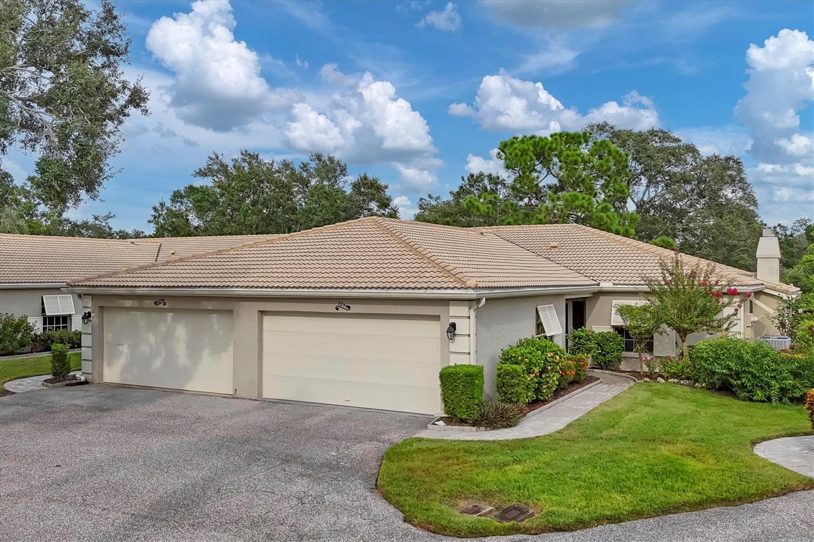 Price Reduced! Lovely location on a cul-de-sac of swaying palms, Papillon consists of private enclaves of maintenance-free villas in The Meadows. You will be greeted by a paver sidewalk leading to the front entry with sidelight. Upon entry, wood flooring from the living room and dining room flow to form a cohesive foundation. The kitchen has a breakfast nook or space for cozy family dining. The living room with high ceilings leads to a wall of sliders opening onto a spacious glassed-in lanai offering you gorgeous water views framed by mossy Live Oak trees. The lanai floor was raised to allow flow from the living room and expands the living space and peaceful views.  A fireplace with convenient electric insert provides ambiance on those cooler evenings.  The spacious primary bedroom features an ensuite bathroom featuring split dual sinks, shower/tub combo, and ample walk-in closet. The guest bedroom is large and just steps away from the guest bathroom with shower/tub combo. A laundry closet houses the full-size washer and dryer and extra storage. Two car garage with extra depth for storage or workbench space and water heater 2017.  Peace of mind with block construction and new tile roof 2012, exterior painted, new downspouts and window shutters, HVAC 2017. Above flood plain in zone x. Enjoy the most delightful resort-style heated community pool just steps away on its own private island for a quick dip or meet neighbors for an outdoor happy hour. Walk to The Meadows Shopping Village for restaurants, new neighborhood bar and restaurants , hair salon, massage therapist, and other convenient services. Papillon HOA has fully-funded reserves and takes pride in a well-managed neighborhood.  Live in a friendly and very active community with 24 hour safety patrol and enjoy the carefree Florida lifestyle! The Meadows offers pay-to-play golf, a highly regarded tennis complex with 15 lighted Har-Tru courts, Jr. Olympic swimming pool with spa, private dog park, basketball, new fitness center, and 10 new pickleball courts. All located within 1,650 acres of tropical mature landscaping with miles of trails, wildlife preserves and over 80 lakes and ponds, while convenient to all that Sarasota offers! Minutes to luxury shopping and dining at UTC Mall, Mote SEA, Nathan Benderson Park for water sports and miles of recreational opportunities, downtown Sarasota for art and cultural activities and world class Gulf beaches.