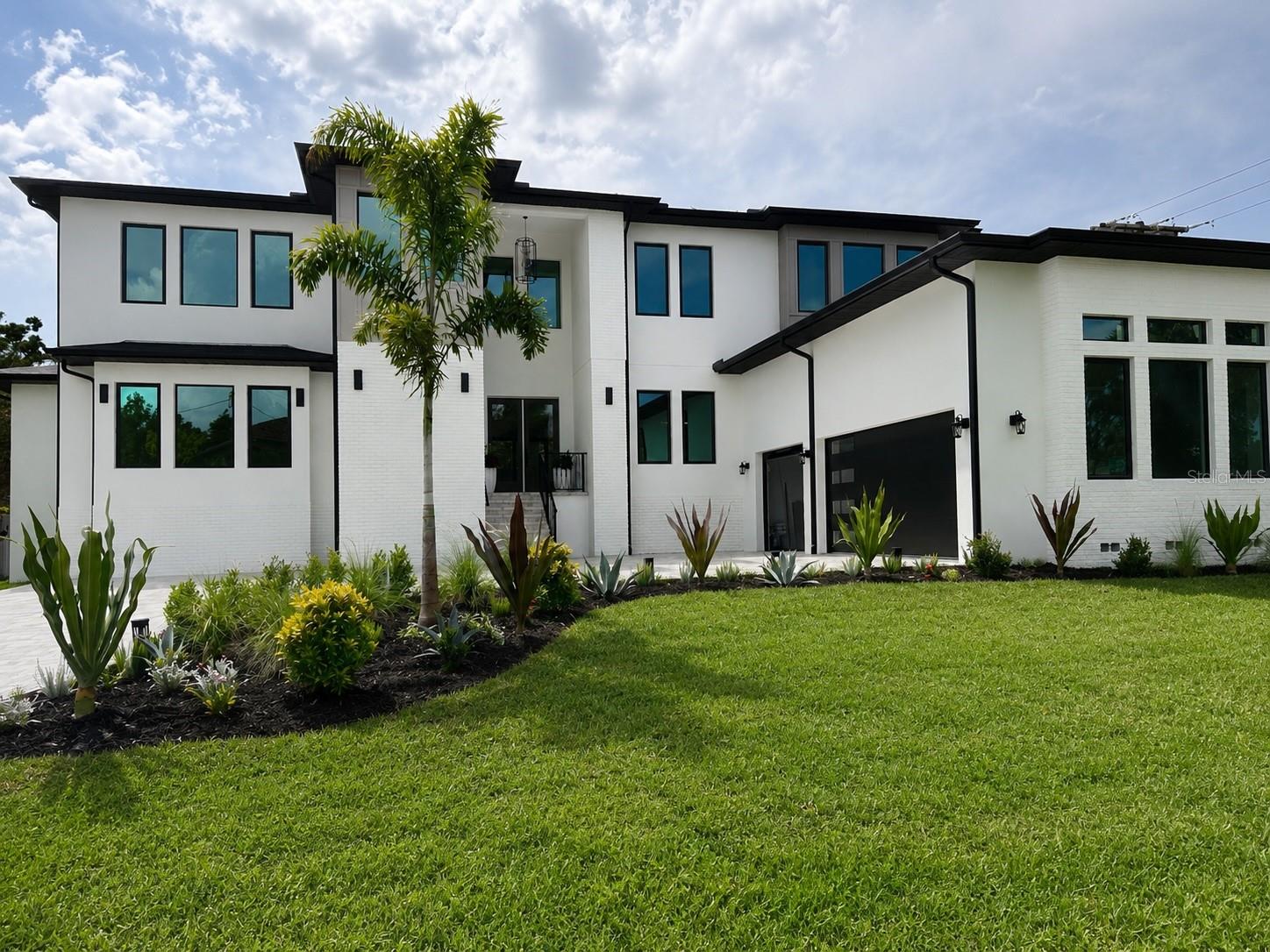 One or more photos have been virtually staged. **** 4TH OF JULY INCENTIVE: Pool package INCLUDED in purchase price on all offers submitted by July 10, 2026. ****  Welcome to an exceptional opportunity in South Tampa -A masterfully crafted contemporary new construction residence offering architectural elegance, modern engineering, and everyday livability on a coveted 0.27-acre corner lot. 5 Bedrooms + Office / 5.5 Baths / 3-Car Garage / 4,771 Sq Ft.
Solid block construction features clean architectural lines, smooth stucco finishes, and striking modern curb appeal. This spacious two-story home offers expansive windows that flood the interior with natural light, sleek dark trim accents, and a neutral palette. The oversized driveway and side-entry garage enhance both functionality and design, while the thoughtfully crafted exterior blends modern elegance with timeless style. Situated on a generous corner lot, this residence presents a rare opportunity for luxury living with a fresh, high-end aesthetic - perfect for buyers seeking modern design, open-concept living, and premium craftsmanship.
A grand double-door entry opens to an oversized foyer and seamless open-concept great room. The chef's kitchen is anchored by an oversized quartz island, a premium Thermador appliance package, custom soft-close cabinetry, and a spacious butler's pantry. The main-level primary suite is a true retreat, featuring a spa-inspired bath with dual vanities, soaking tub, walk-in shower, and custom walk-in closet. A second full bath on the main floor serves guests with equal refinement.
Upstairs offers 4 bedrooms and 3.5 baths, including 2 en-suite bedrooms ideal for multigenerational living or a second primary suite. Built for modern efficiency with impact-rated windows and doors, LED lighting, and ceiling fans throughout. The 3-car garage and fenced side yard provide the perfect canvas for your dream pool and outdoor retreat. The pool package is ready to be added to the contract. 
 4706 W San Carlos St, Tampa, FL 33629 is zoned for top-rated Mabry / Coleman / Plant schools. Minutes to Tampa International Airport, Hyde Park Village, Downtown Tampa, International Plaza, St. Petersburg, and the Beaches - with easy access to I-275, Veterans Expressway, and Gandy Blvd.
