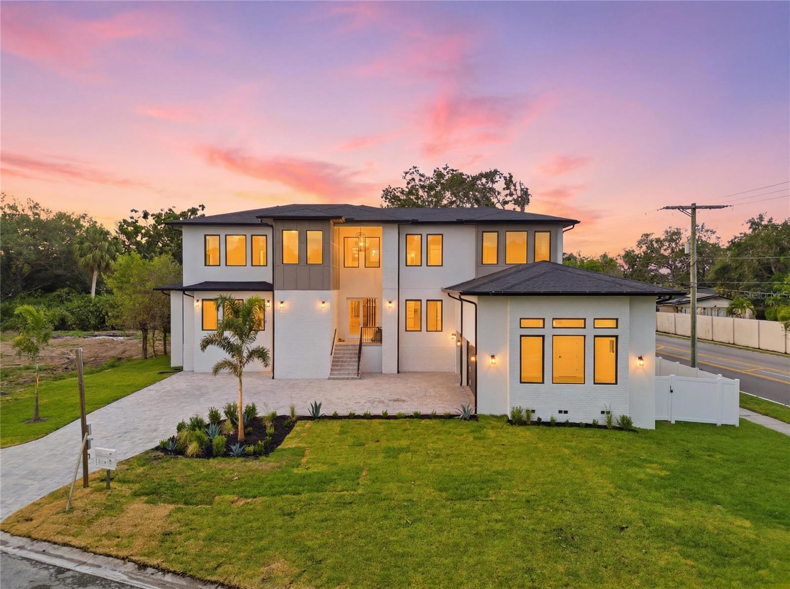 Welcome to an exceptional opportunity in South Tampa - 4706 W San Carlos St, Tampa, FL 33629. A masterfully crafted contemporary new construction residence offering architectural elegance, modern engineering, and everyday livability on a coveted 0.27-acre corner lot. 5 Bedrooms + Office / 5.5 Baths / 3-Car Garage / 4,771 Sq Ft.
Solid block construction features clean architectural lines, smooth stucco finishes, and striking modern curb appeal. This spacious two-story home offers expansive windows that flood the interior with natural light, sleek dark trim accents, and a neutral palette. The oversized driveway and side-entry garage enhance both functionality and design, while the thoughtfully crafted exterior blends modern elegance with timeless style. Situated on a generous corner lot, this residence presents a rare opportunity for luxury living with a fresh, high-end aesthetic - perfect for buyers seeking modern design, open-concept living, and premium craftsmanship.
A grand double-door entry opens to an oversized foyer and seamless open-concept great room. The chef's kitchen is anchored by an oversized quartz island, a premium Thermador appliance package, custom soft-close cabinetry, and a spacious butler's pantry. The main-level primary suite is a true retreat, featuring a spa-inspired bath with dual vanities, soaking tub, walk-in shower, and custom walk-in closet. A second full bath on the main floor serves guests with equal refinement.
Upstairs offers 4 bedrooms and 3.5 baths, including 2 en-suite bedrooms ideal for multigenerational living or a second primary suite. Built for modern efficiency with PGT impact-rated windows and doors, LED lighting, and ceiling fans throughout. The 3-car garage and fenced side yard provide the perfect canvas for your dream pool and outdoor retreat. The pool package is ready to be added to the contract. 
Zoned for top-rated Mabry / Coleman / Plant schools. Minutes to Tampa International Airport, Hyde Park Village, Downtown Tampa, International Plaza, St. Petersburg, and the Beaches - with easy access to I-275, Veterans Expressway, and Gandy Blvd.